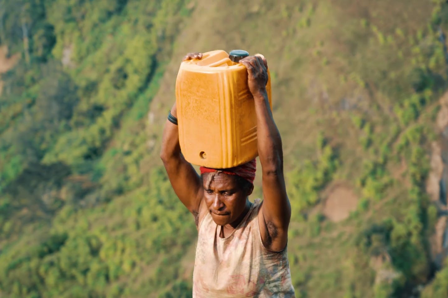 Carrying jerrycan filled with water.