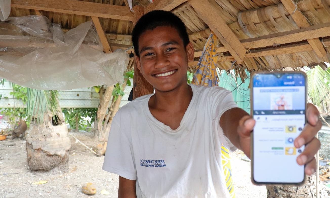 Child holding up learning passport on phone