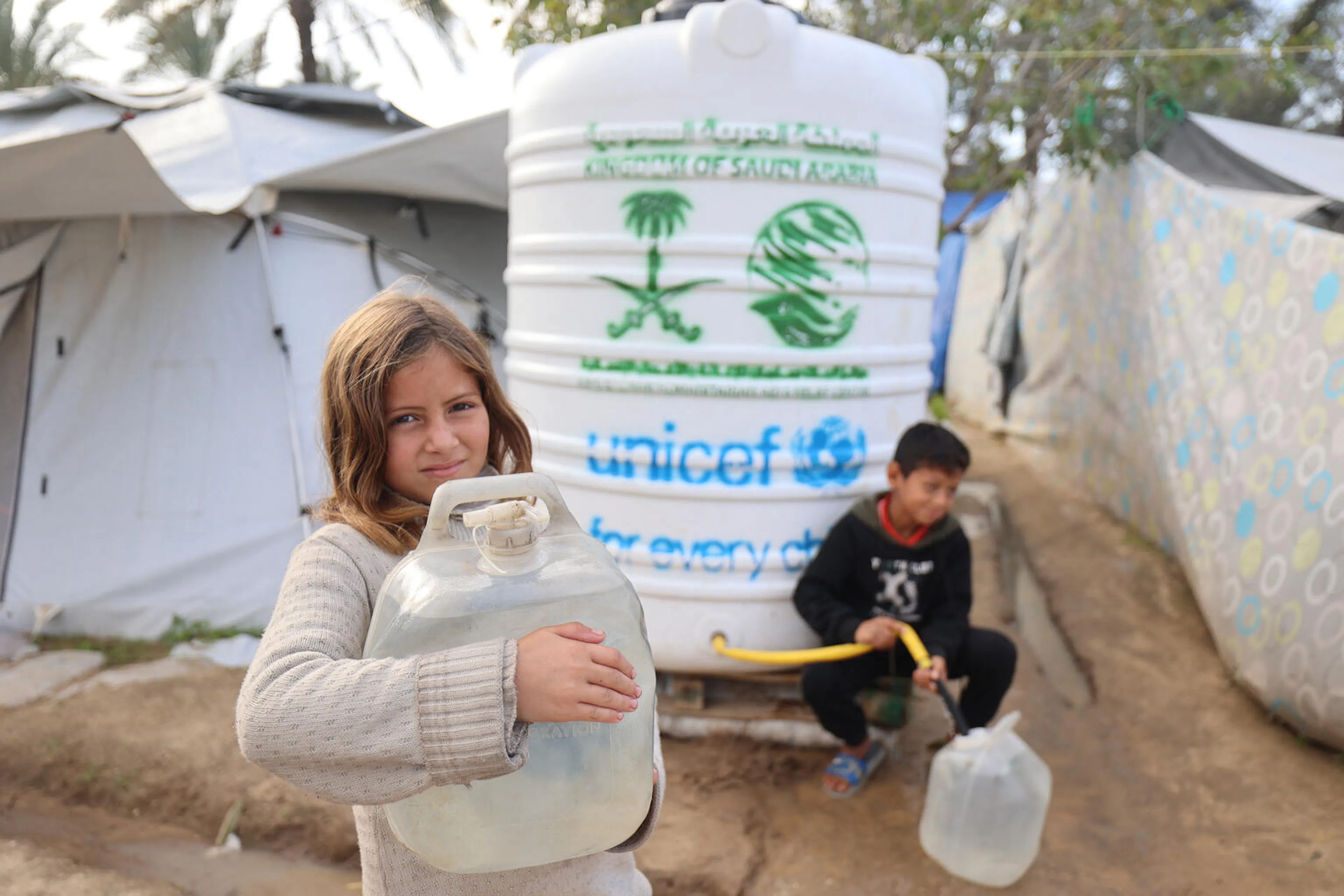 Fatima collects clean water in Gaza