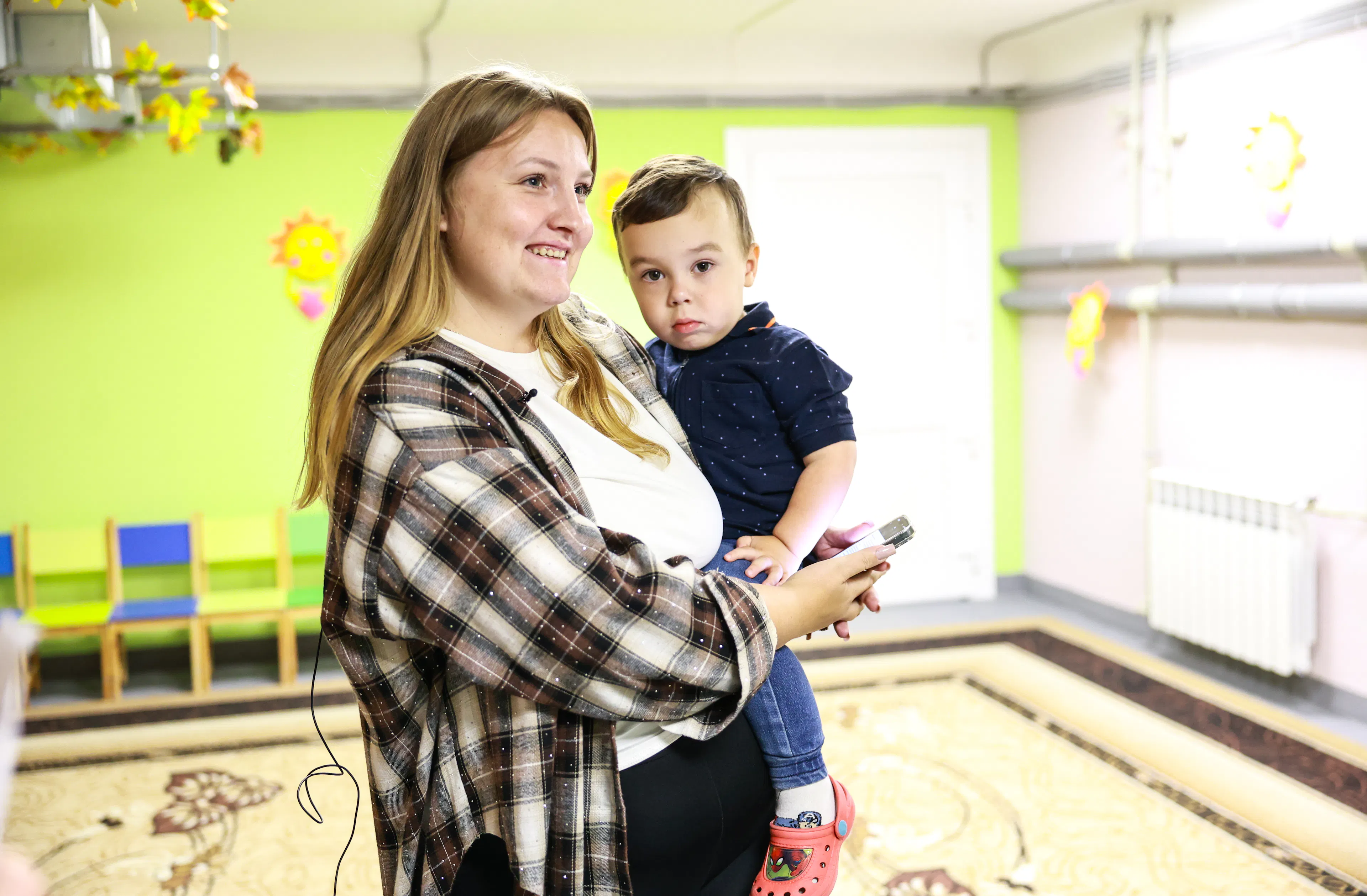 Zaporizhzhia, Ukraine. In the newly renovated shelter at Karamelka kindergarten Alina spends time with her son Artem, who attends the kindergarten. Although the family lives in another neighbourhood and has to travel some distance, Alina chose Karamelka because a protective shelter was being prepared there, allowing Artem to continue learning and playing during air raid alerts.
