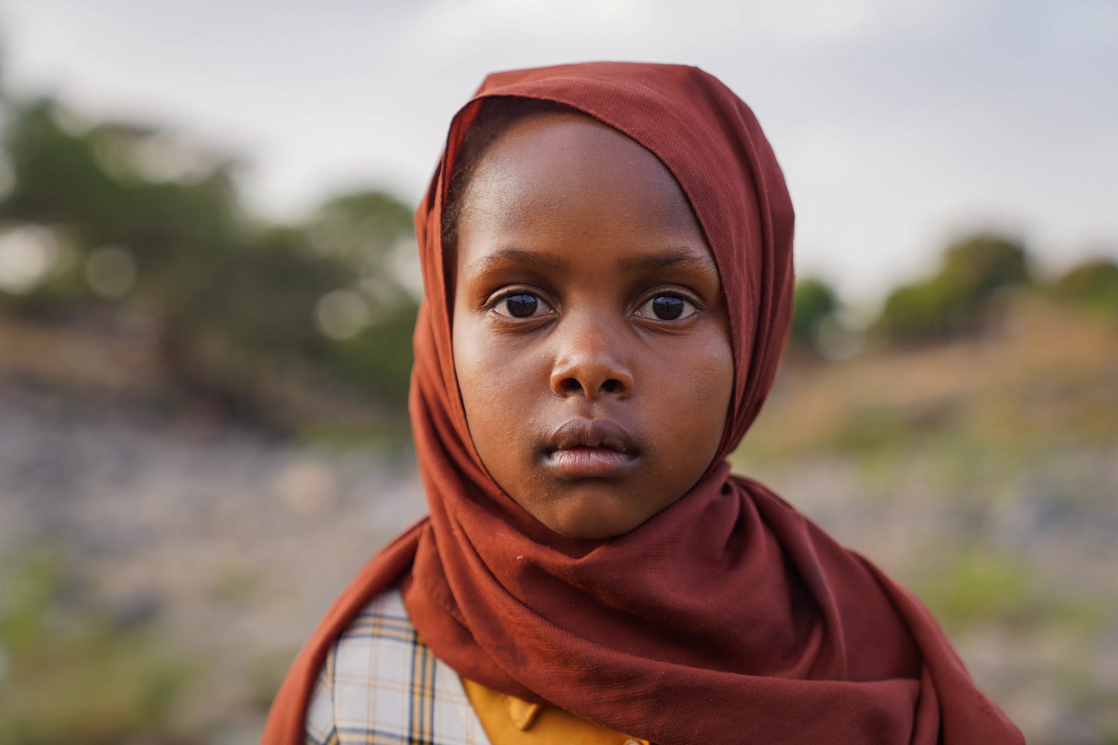 9-year-old Tuqaa and her family have been displaced by the war in Sudan.