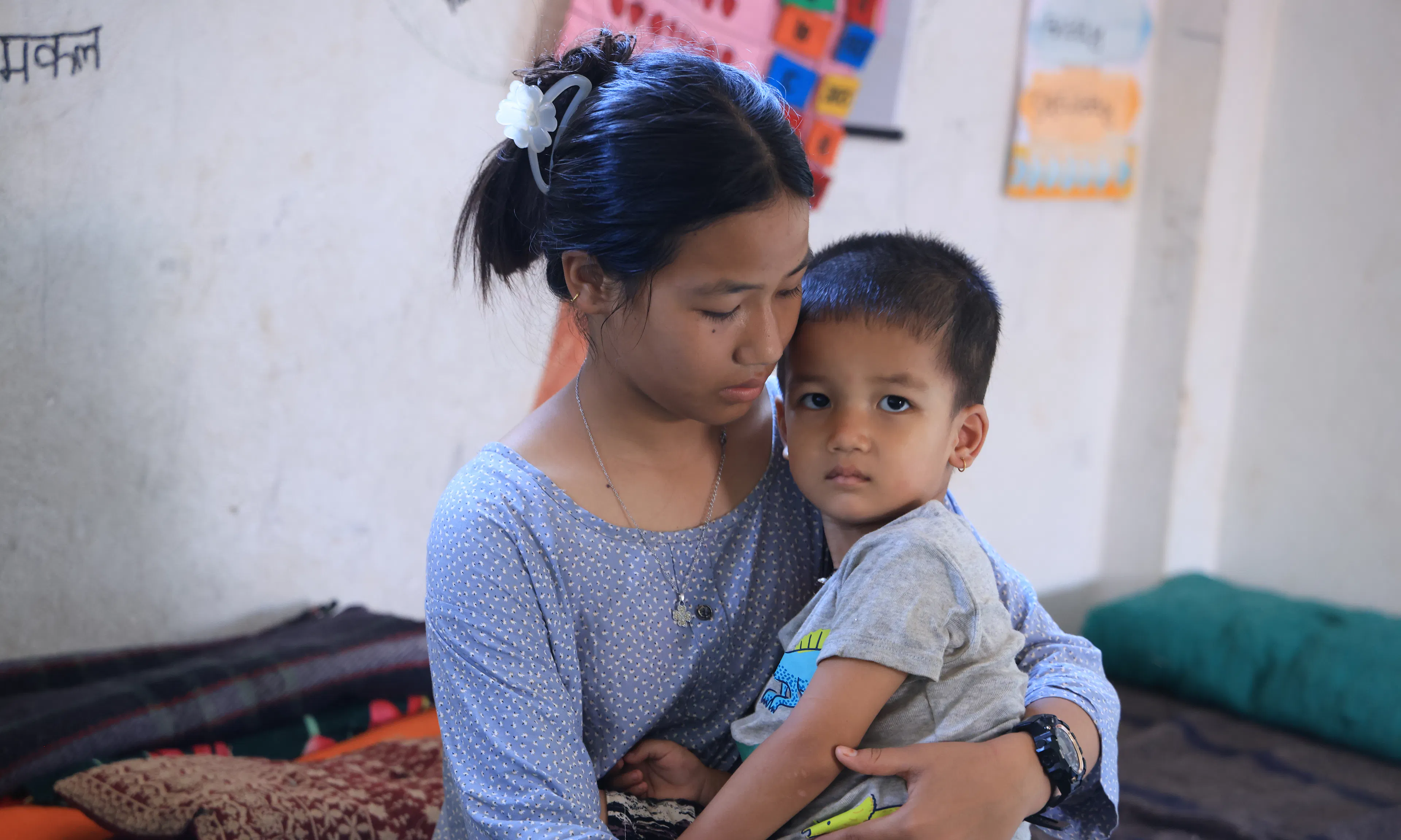 13 year old Sonika holding her 3 year old brother after devastating floods hit Nepal