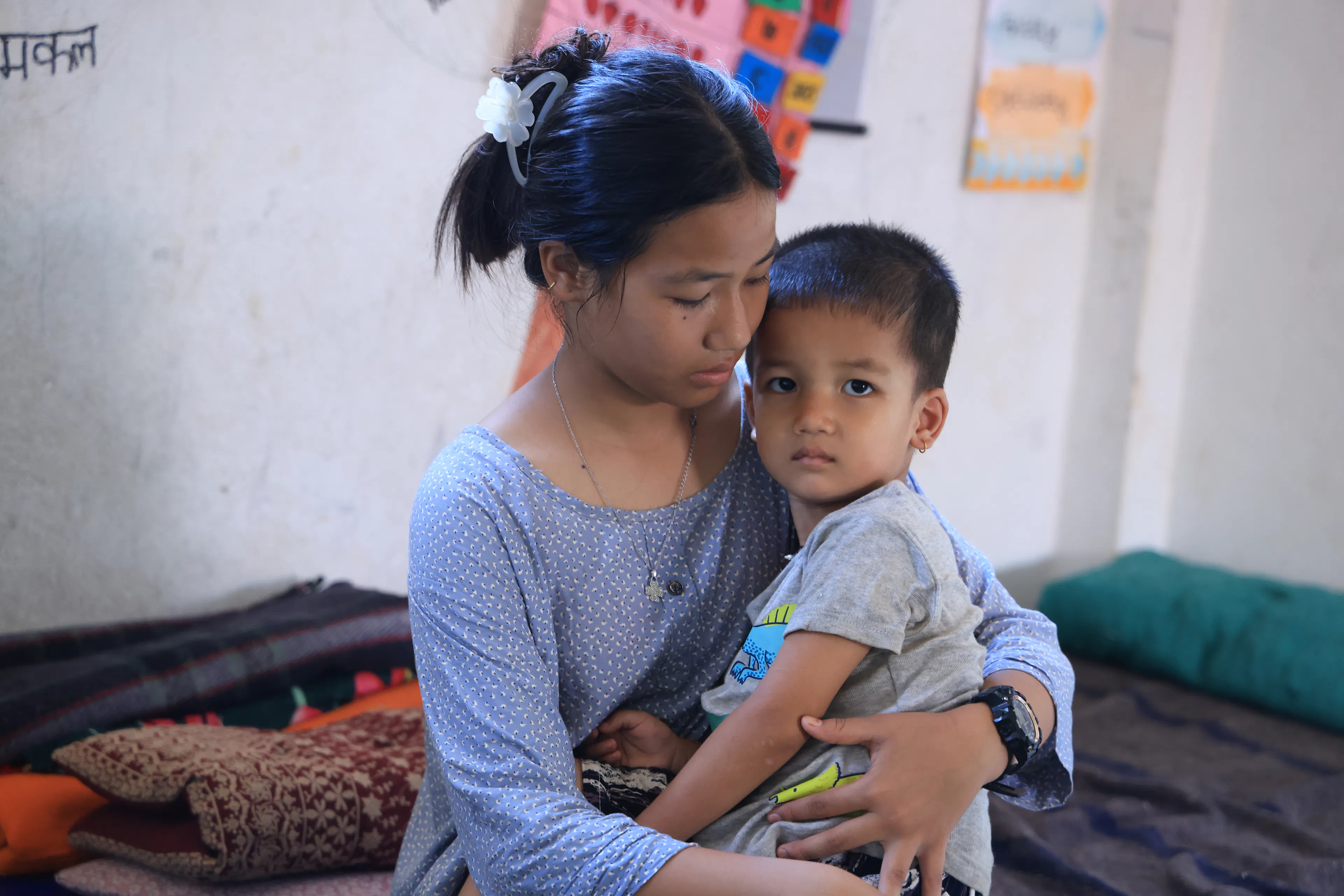 13 year old Sonika holding her 3 year old brother after devastating floods hit Nepal