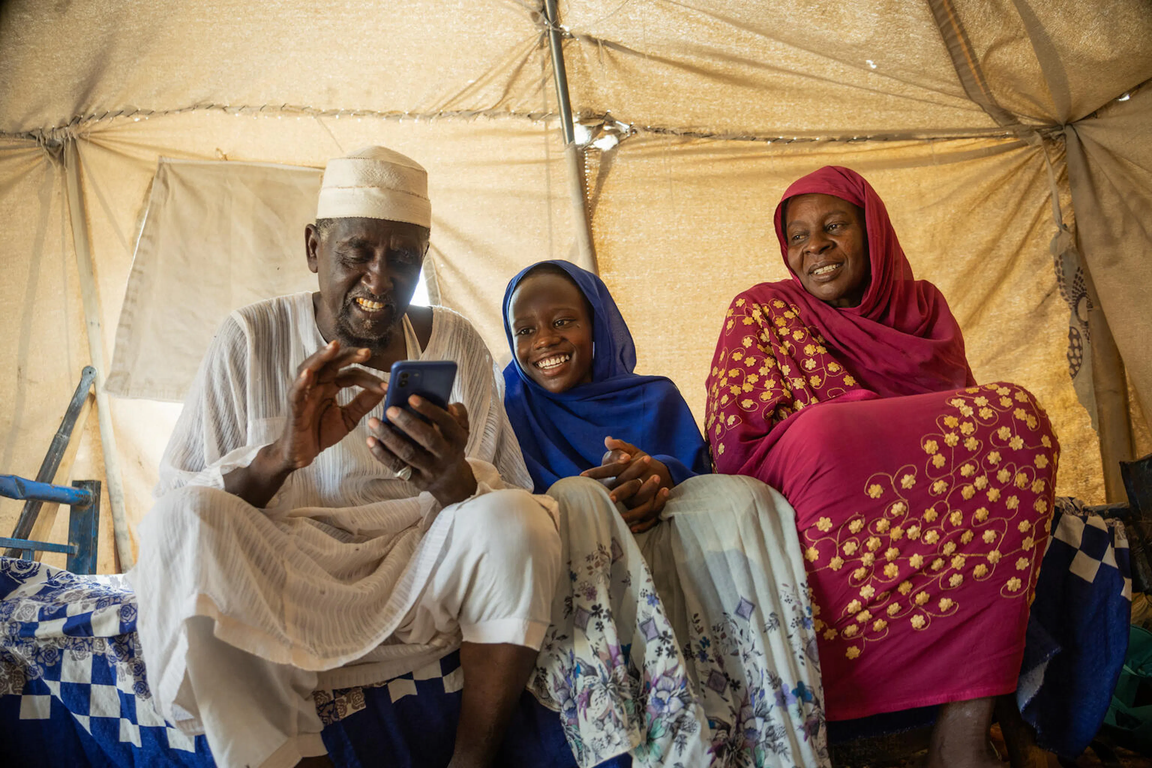 14 year old Mariam with her grandparents in an IDP camp in Sudan