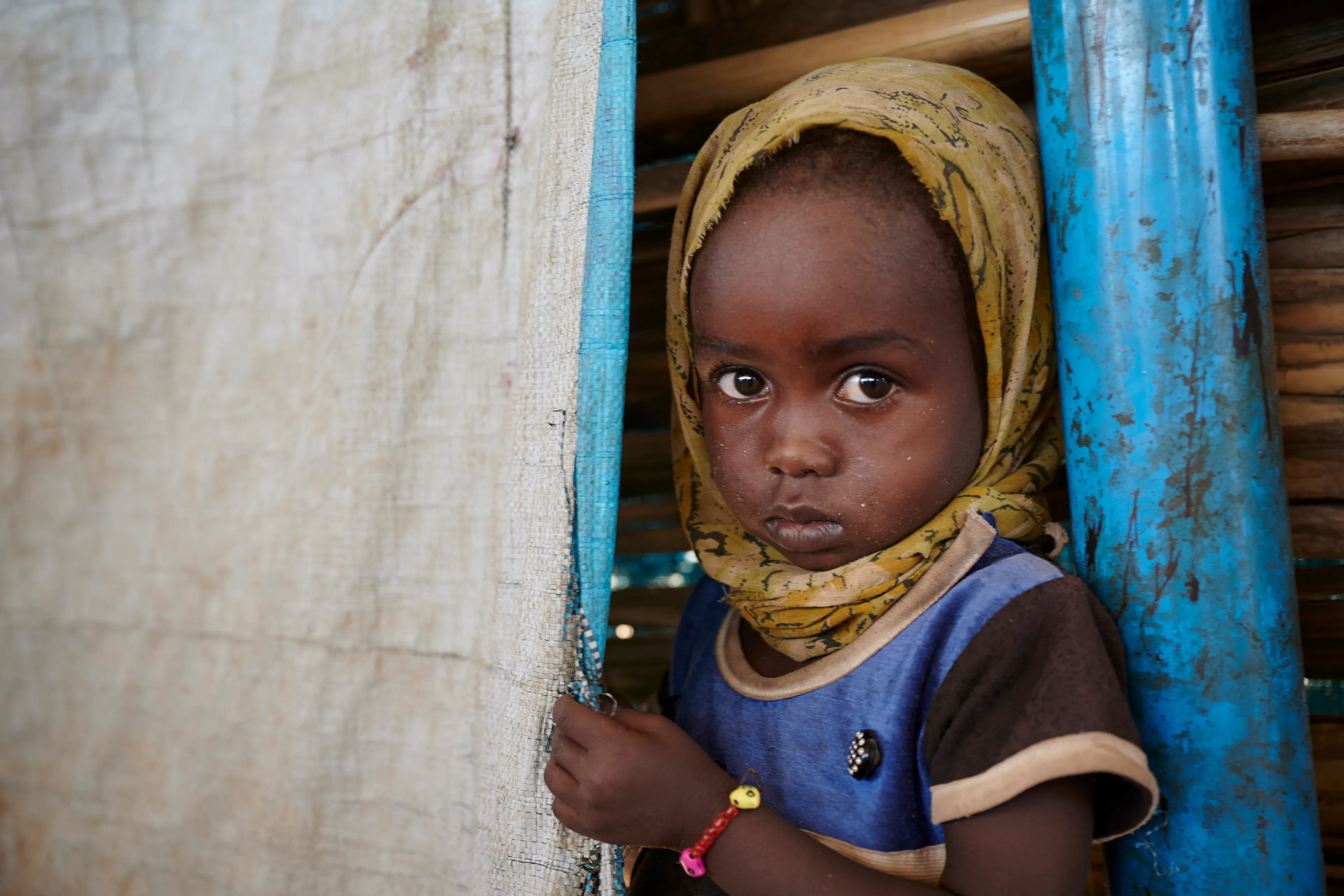 A girl stands at UNICEF supported Child Friendly Centre in Dabba Naiva IDP camp in Tawila, North Darfur, Sudan.