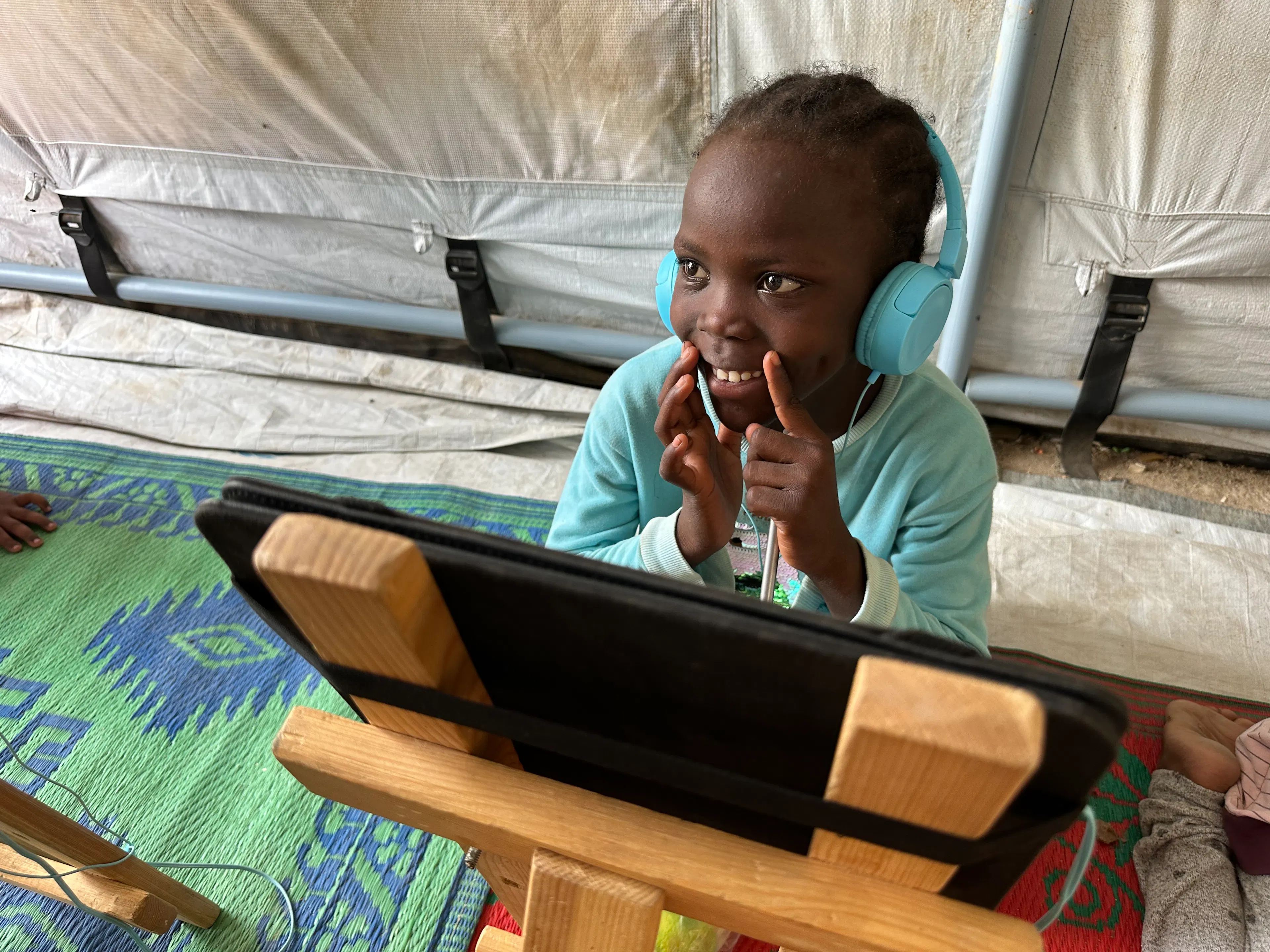 Girl with headphones and tablet