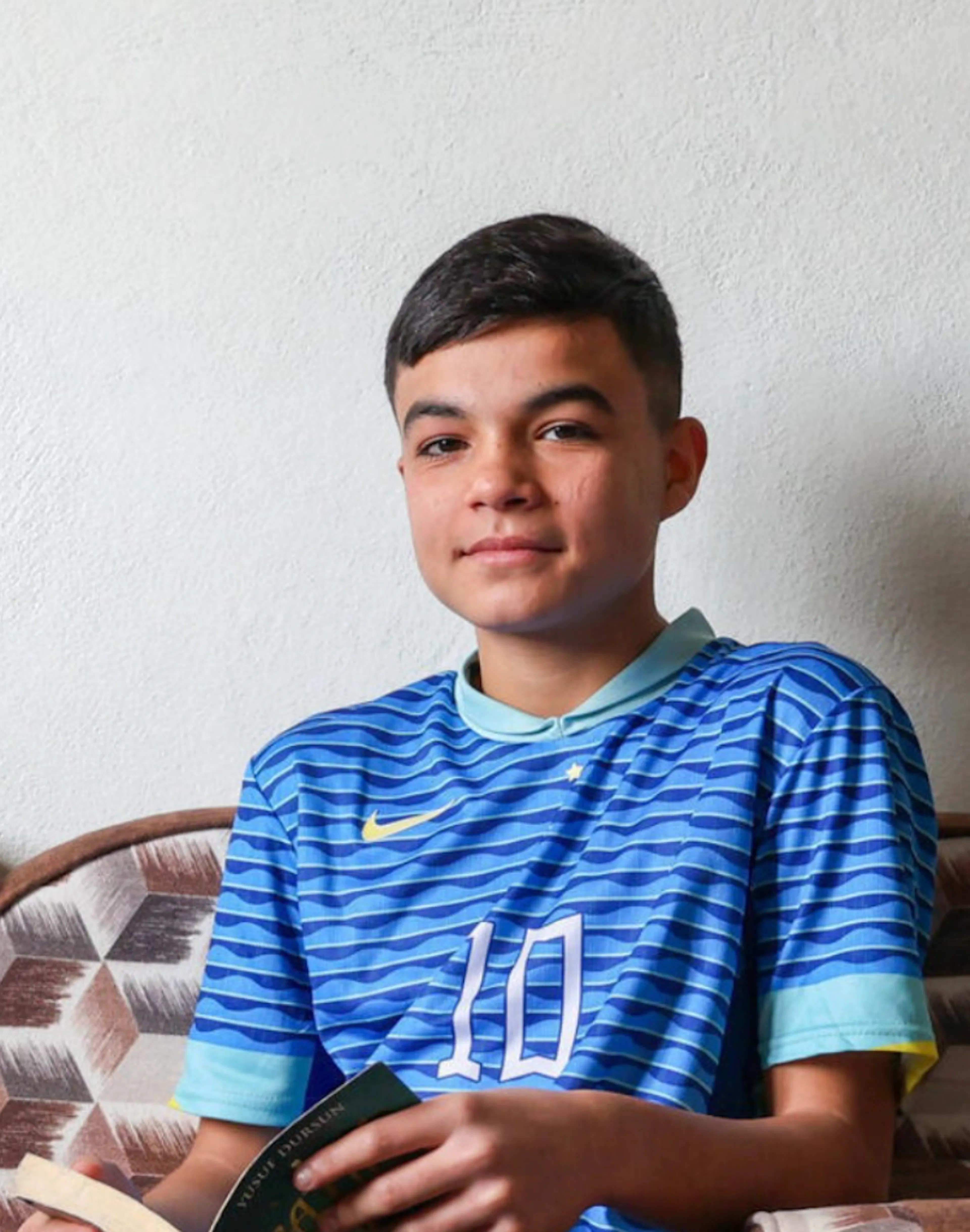 Teen in soccer jersey
