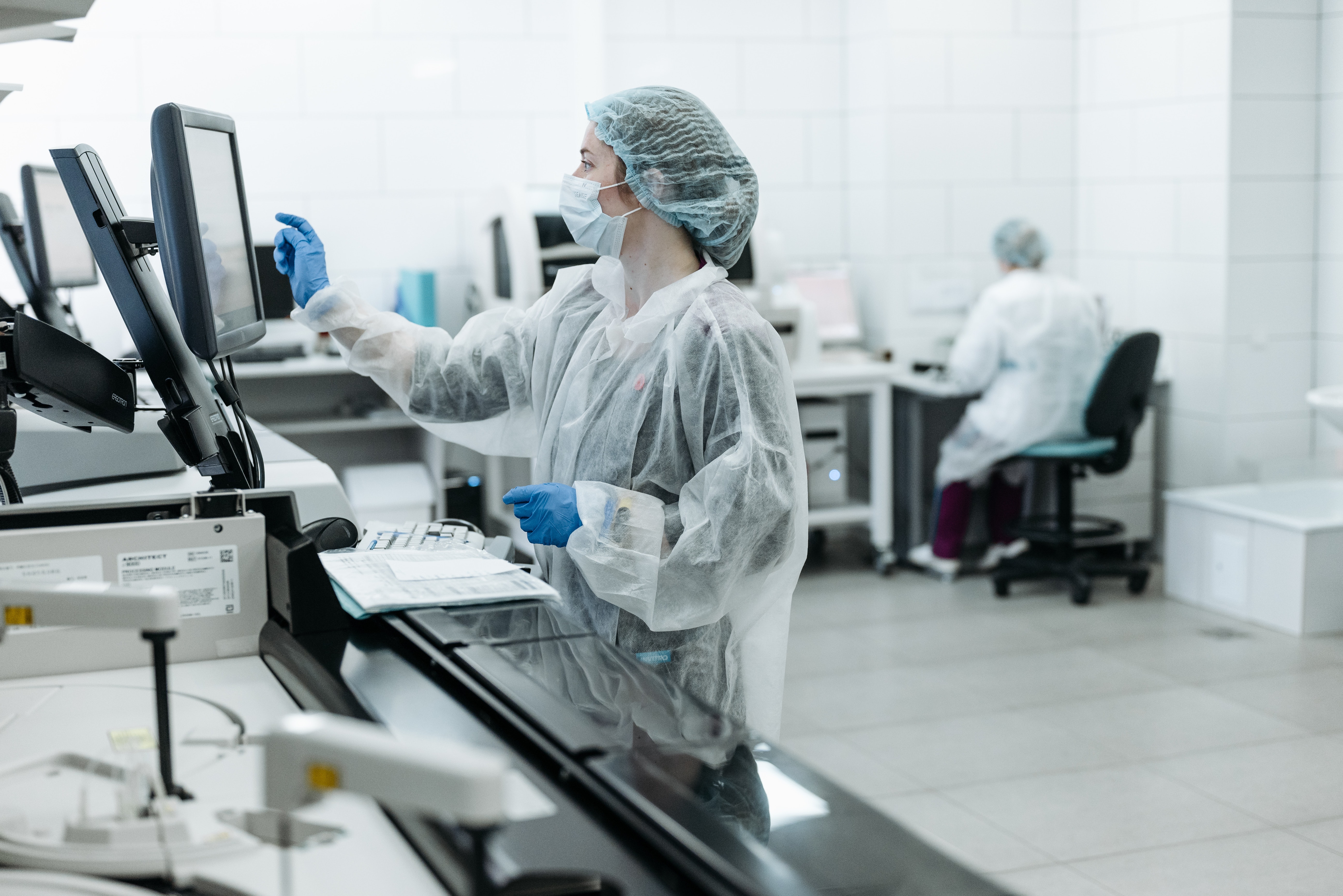 Lab automator in protective clothing