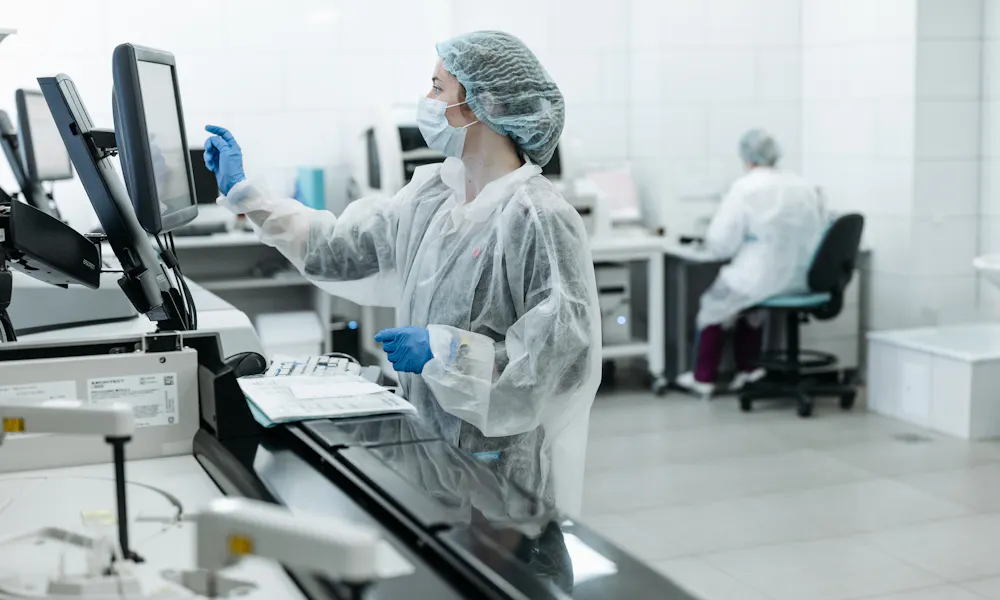 Lab automator in protective clothing