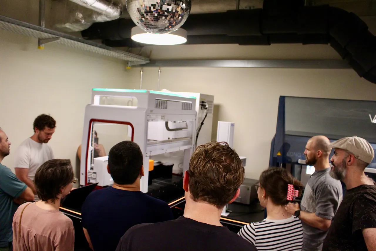 The UniteLabs team gathers around the cell culture workcell they built