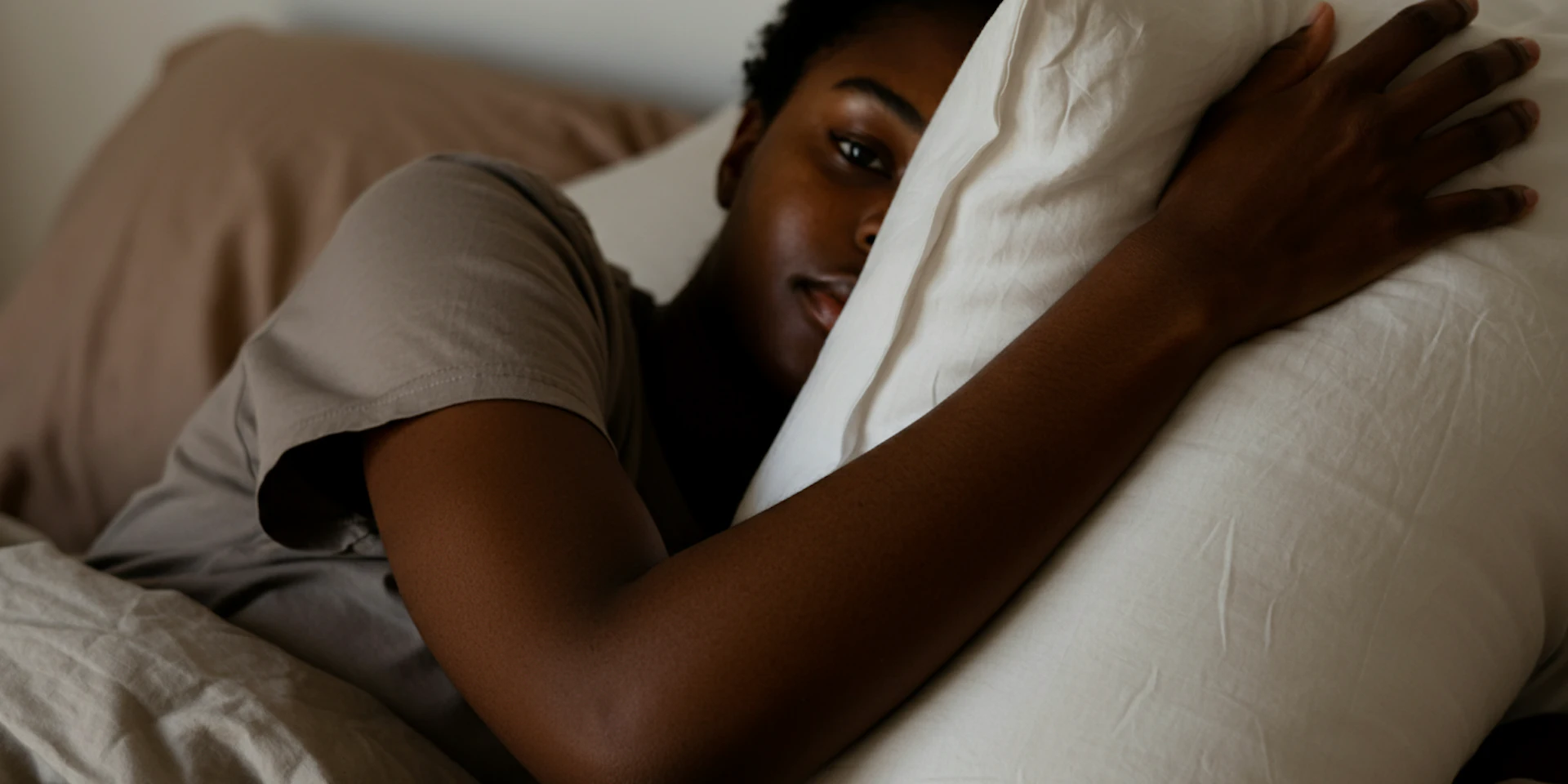 A man reading documents on a sofa, reflecting on the importance of understanding data insights in mental health program outcomes.