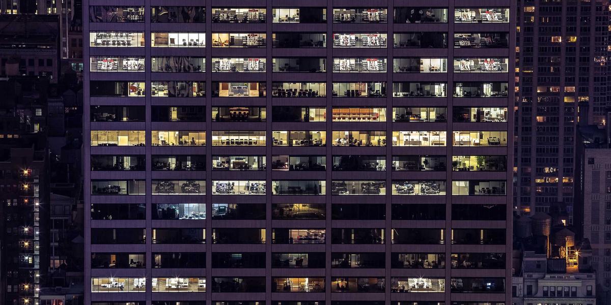A modern office space showing collaboration among diverse teams, symbolizing the importance of workplace mental health interventions.