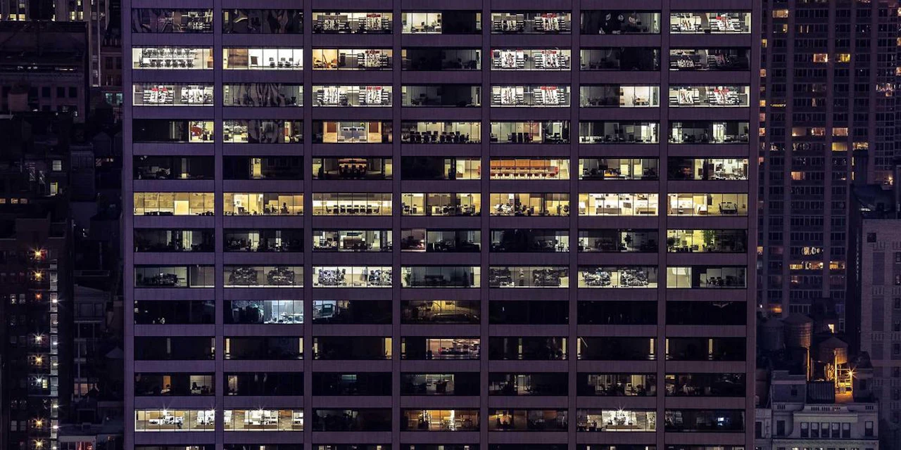 A modern office space showing collaboration among diverse teams, symbolizing the importance of workplace mental health interventions.