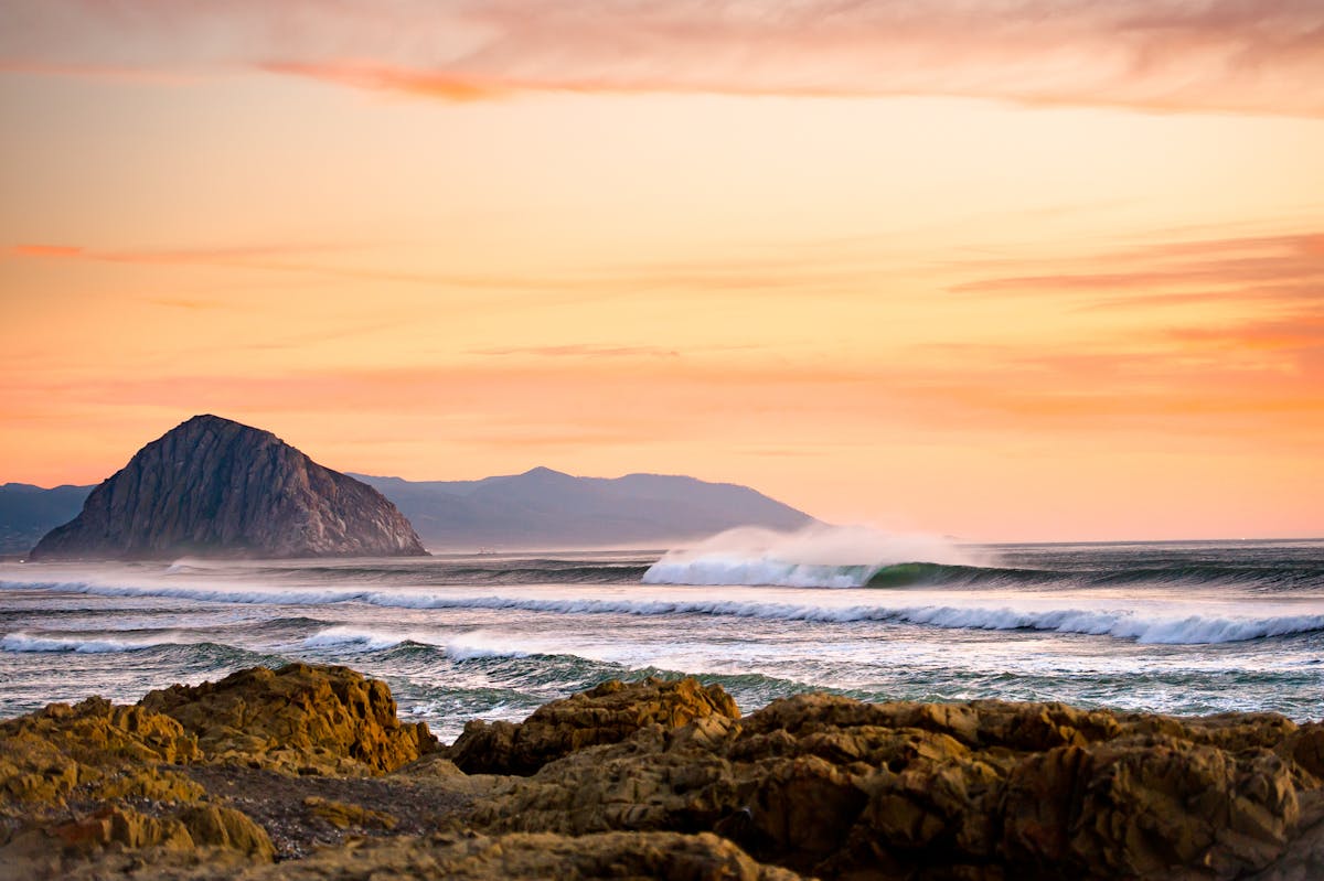 Photography of the shore with orange clouds.