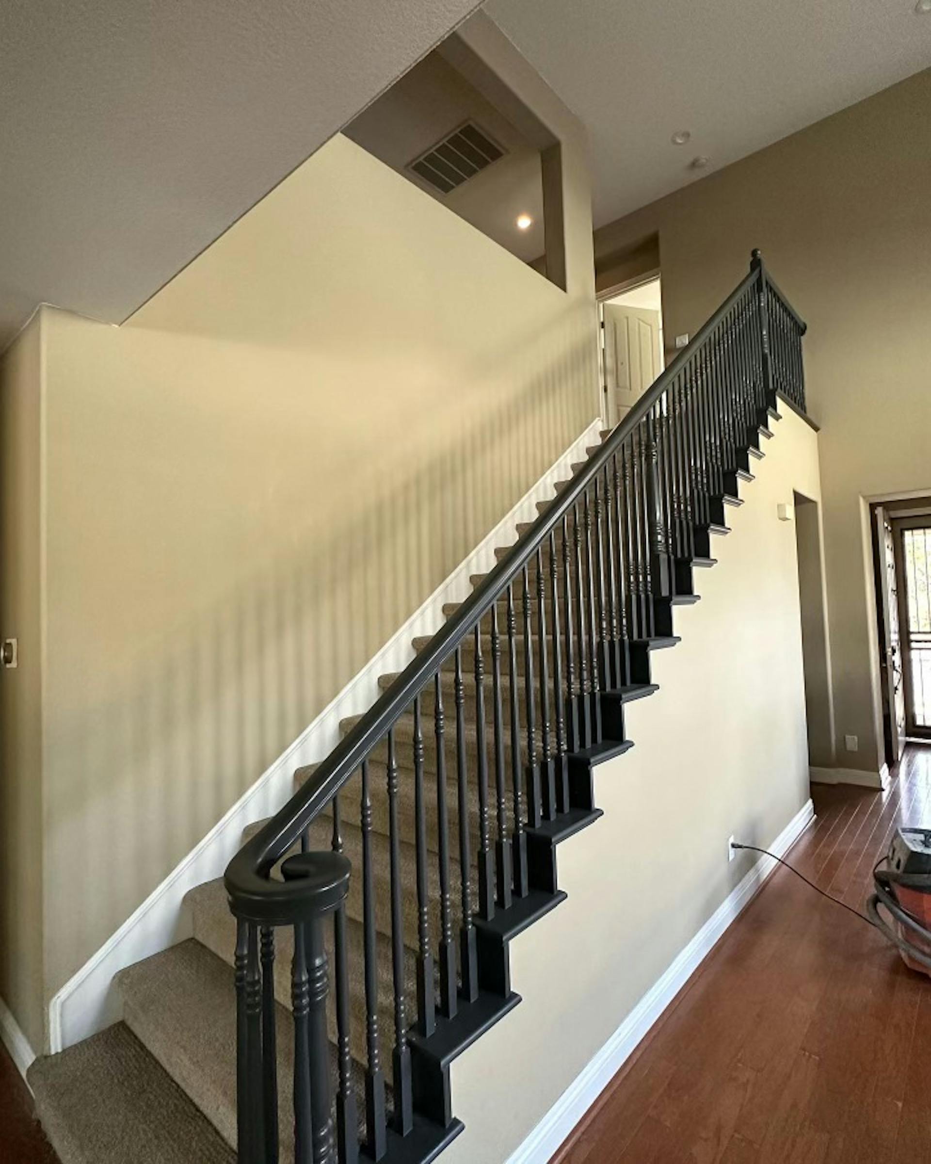 A wide angle view from the side of a dark color banister