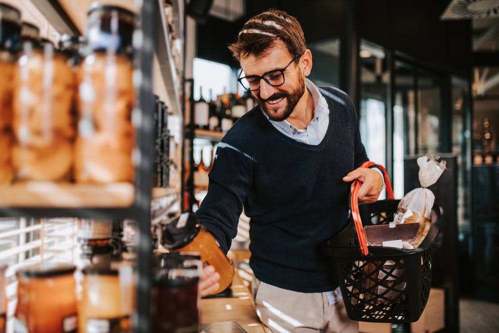 A man enjoys shopping in the supermarket