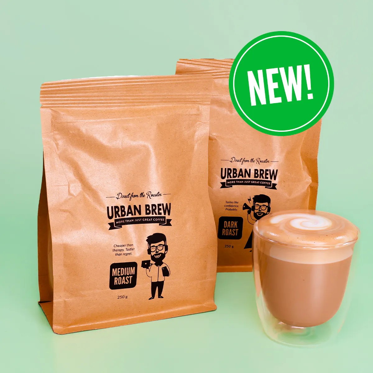 New Urban Brew 250g Medium and Dark Roast bags beside a glass of cafe latte