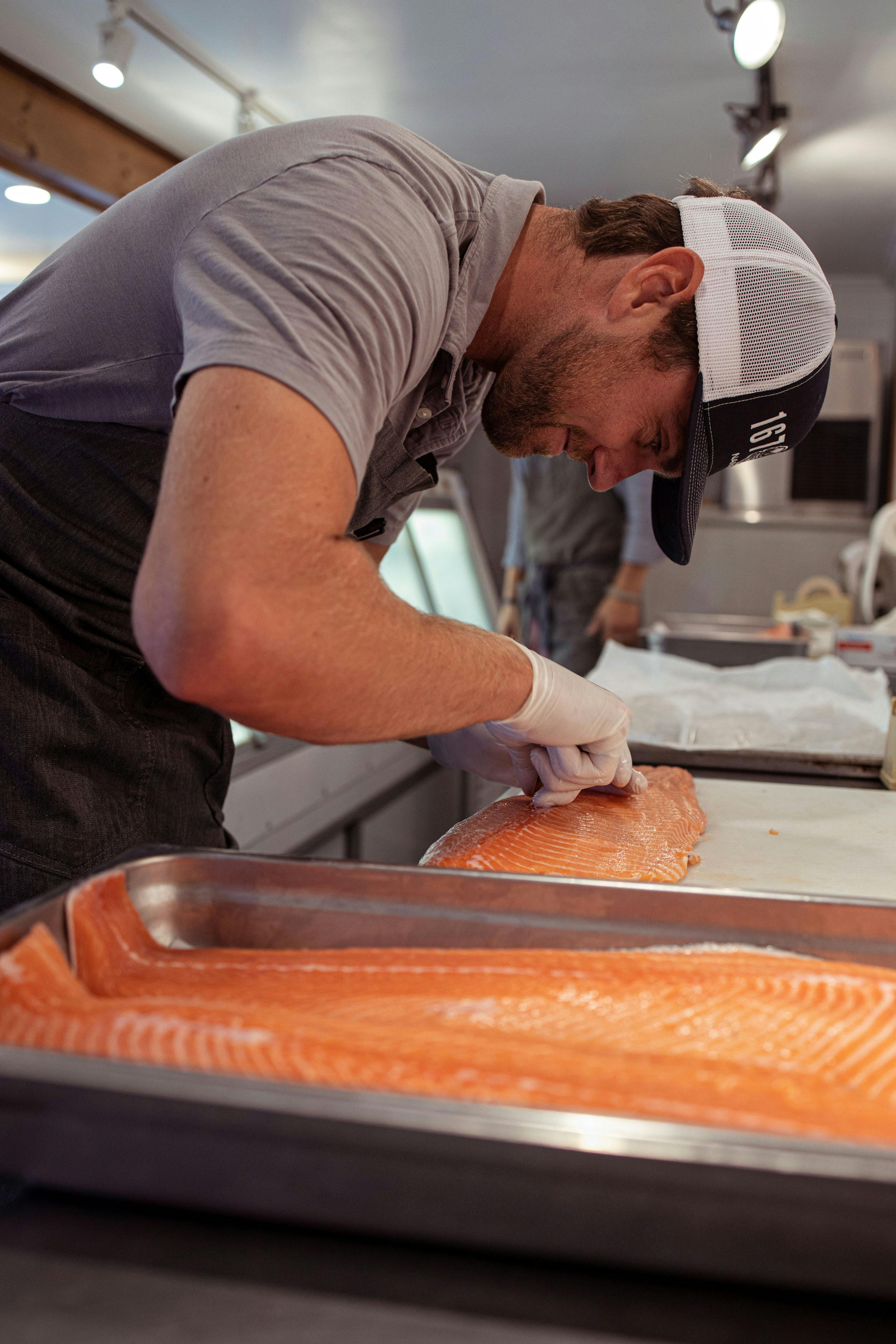Jesse filleting a salmon at the 167 Market in Nantucket.