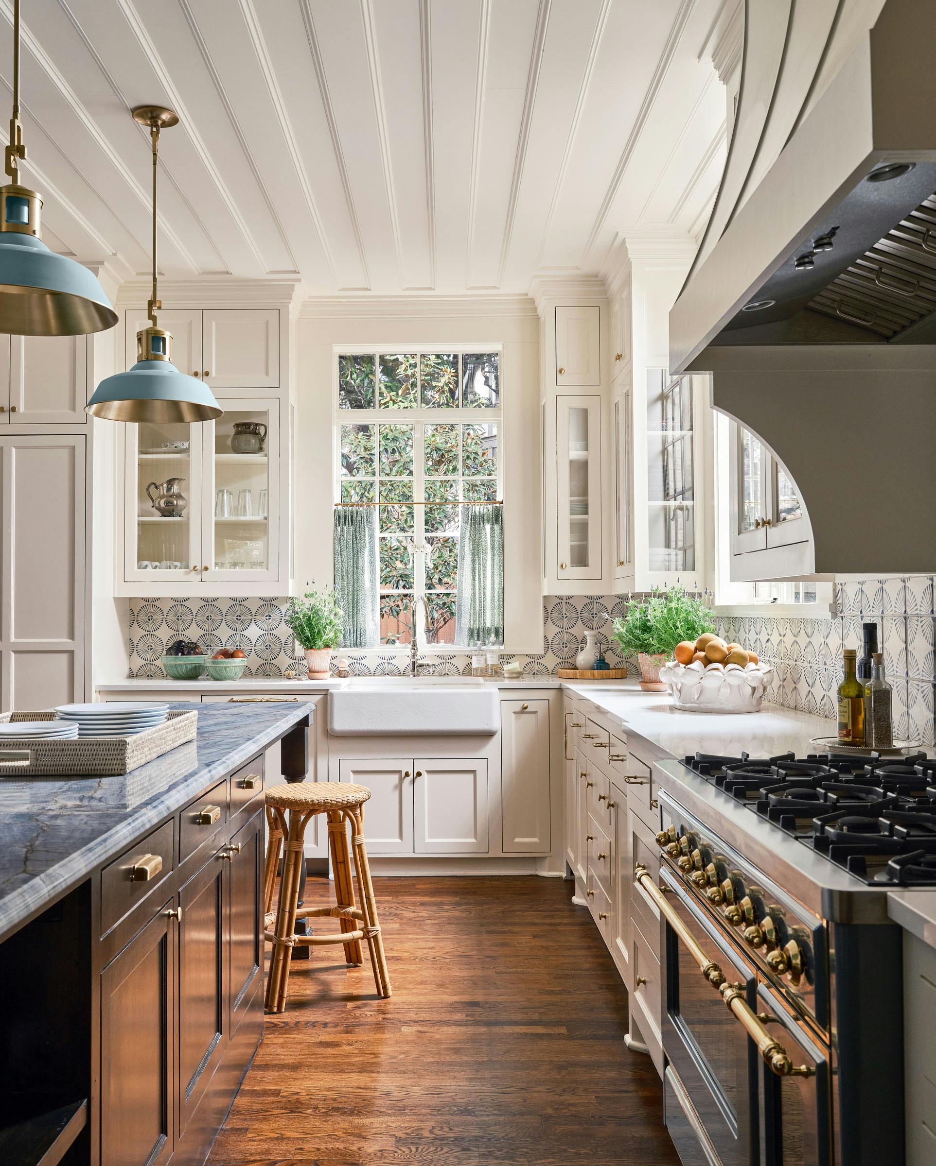 Mac shown in UECo. Signature Color Smoke Blue painted finish with hewn brass lacquered accents and hewn brass lacquered shade interior. Interiors by Tori Rubinson. Photography by Stephen Karlisch. Styled by Melanie McKinley.