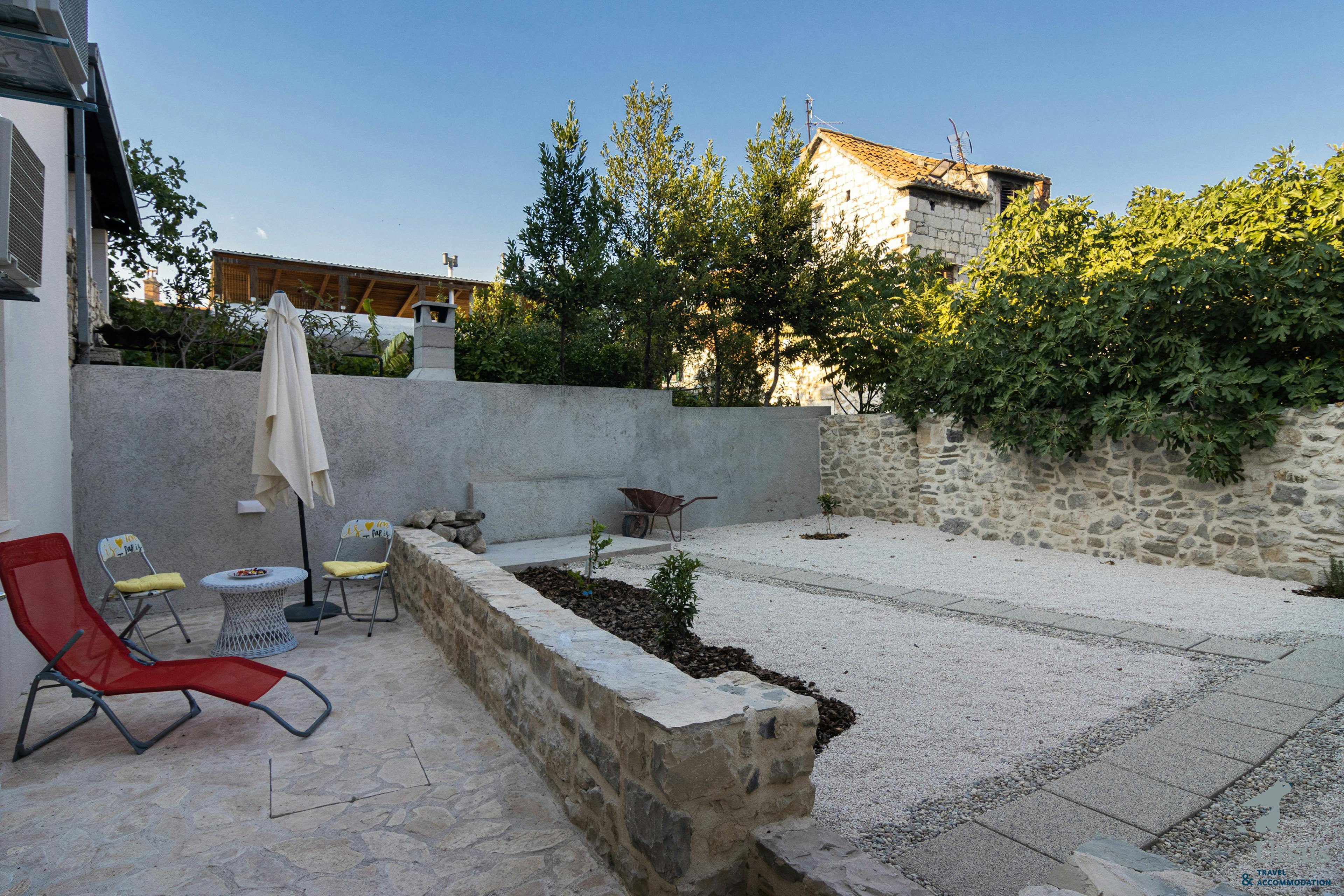 Private courtyard with a grill and  a shower