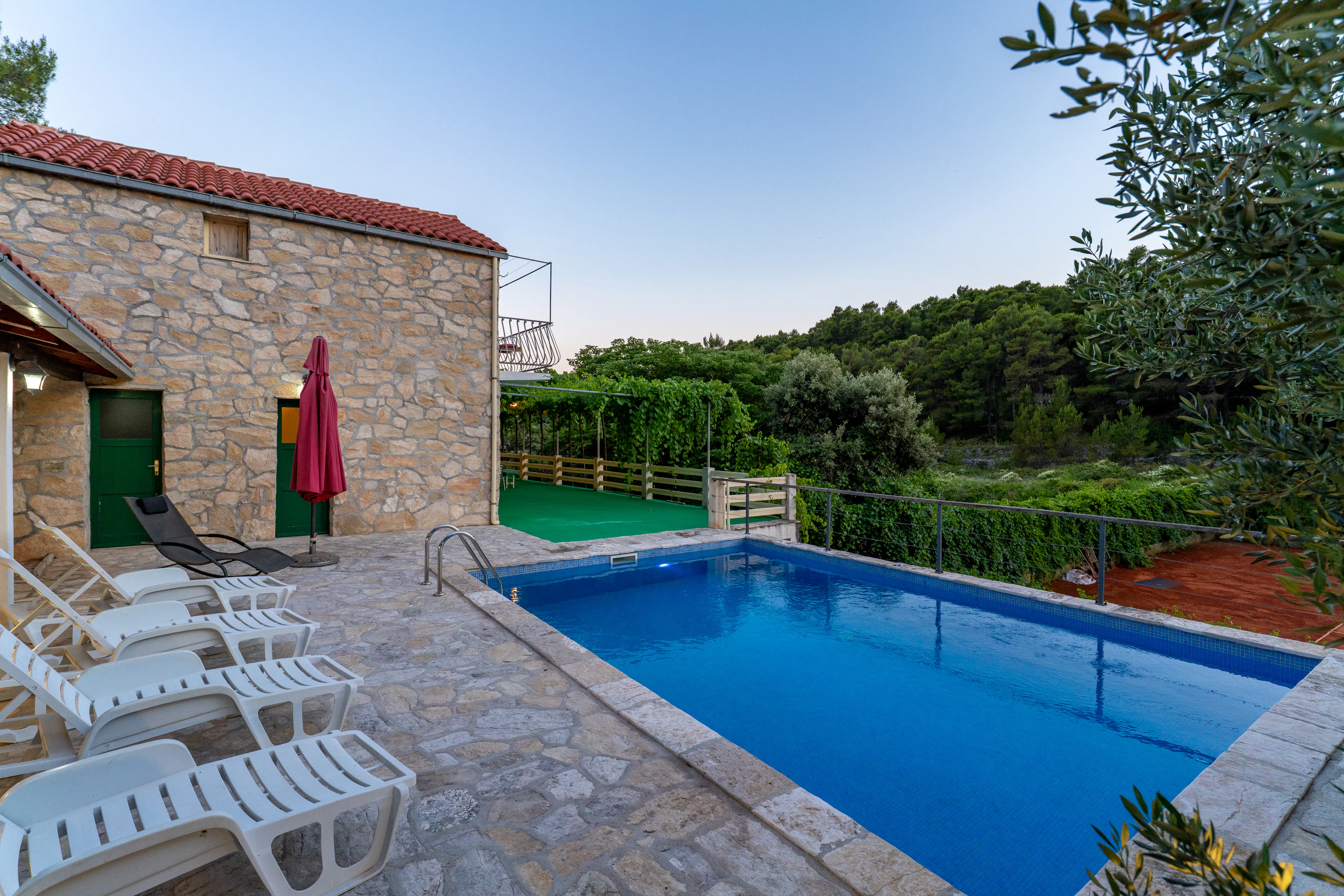 Pool overlooking the shared tennis court