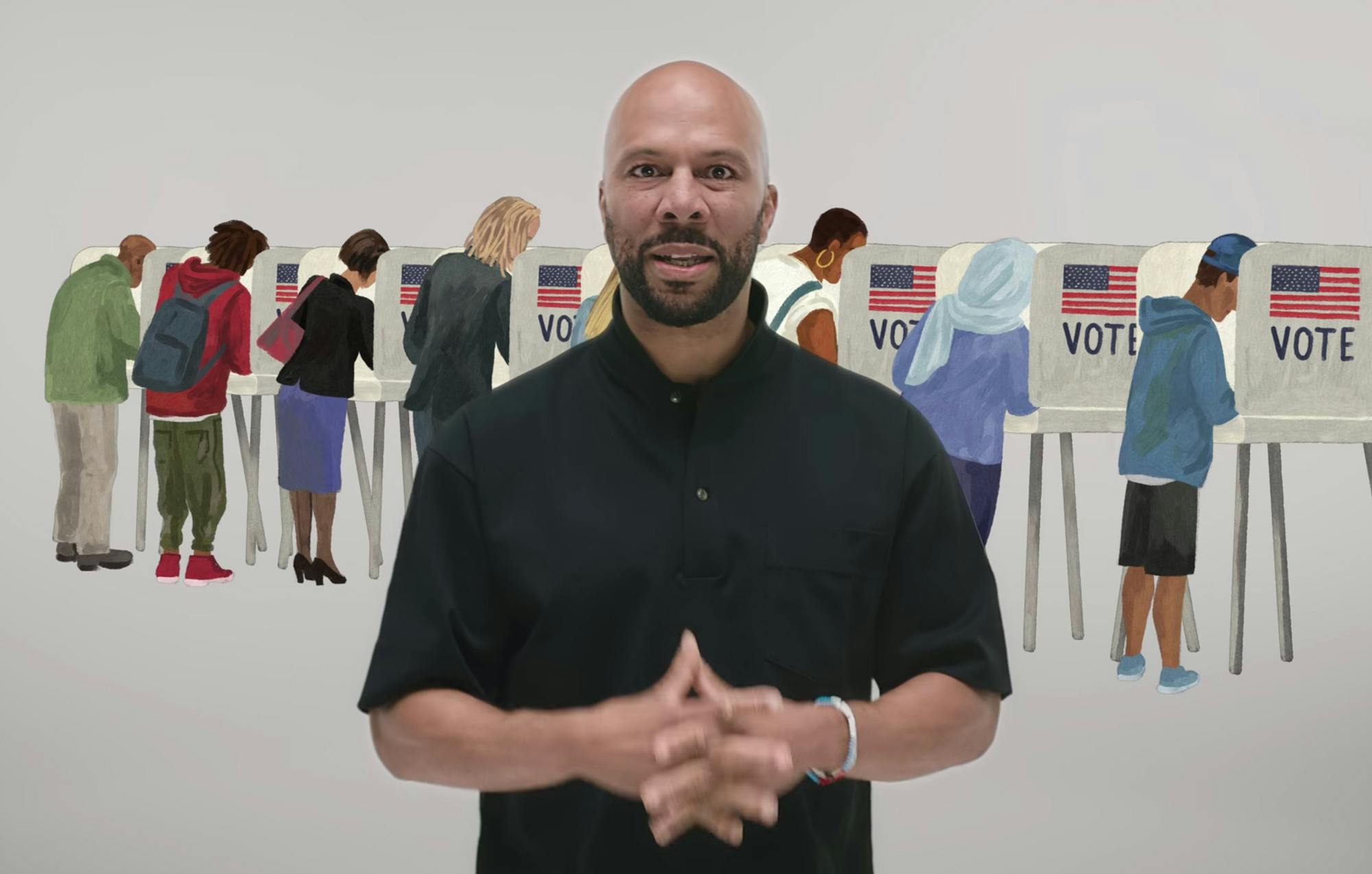 A man standing in front of voters and voting booths