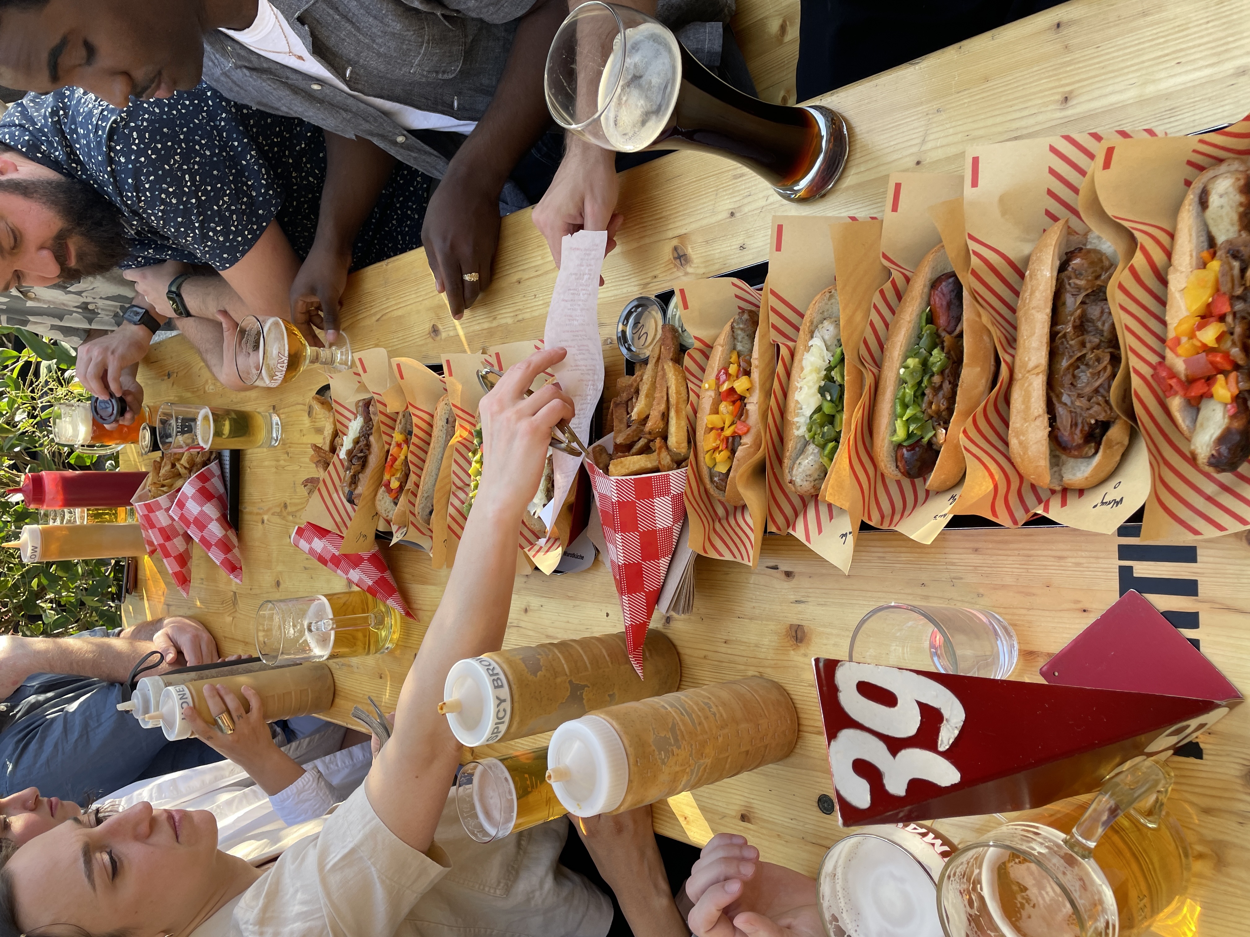 Many hotdogs on a table