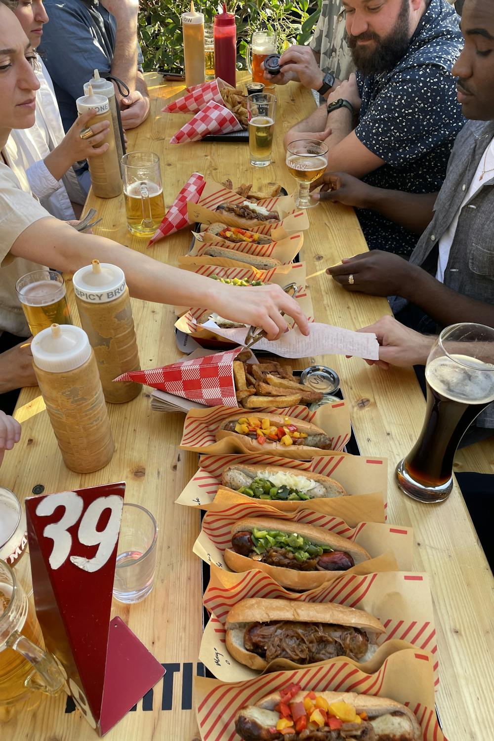 Many hotdogs on a table