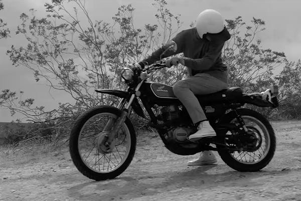 B&W photo of a person on a motorbike