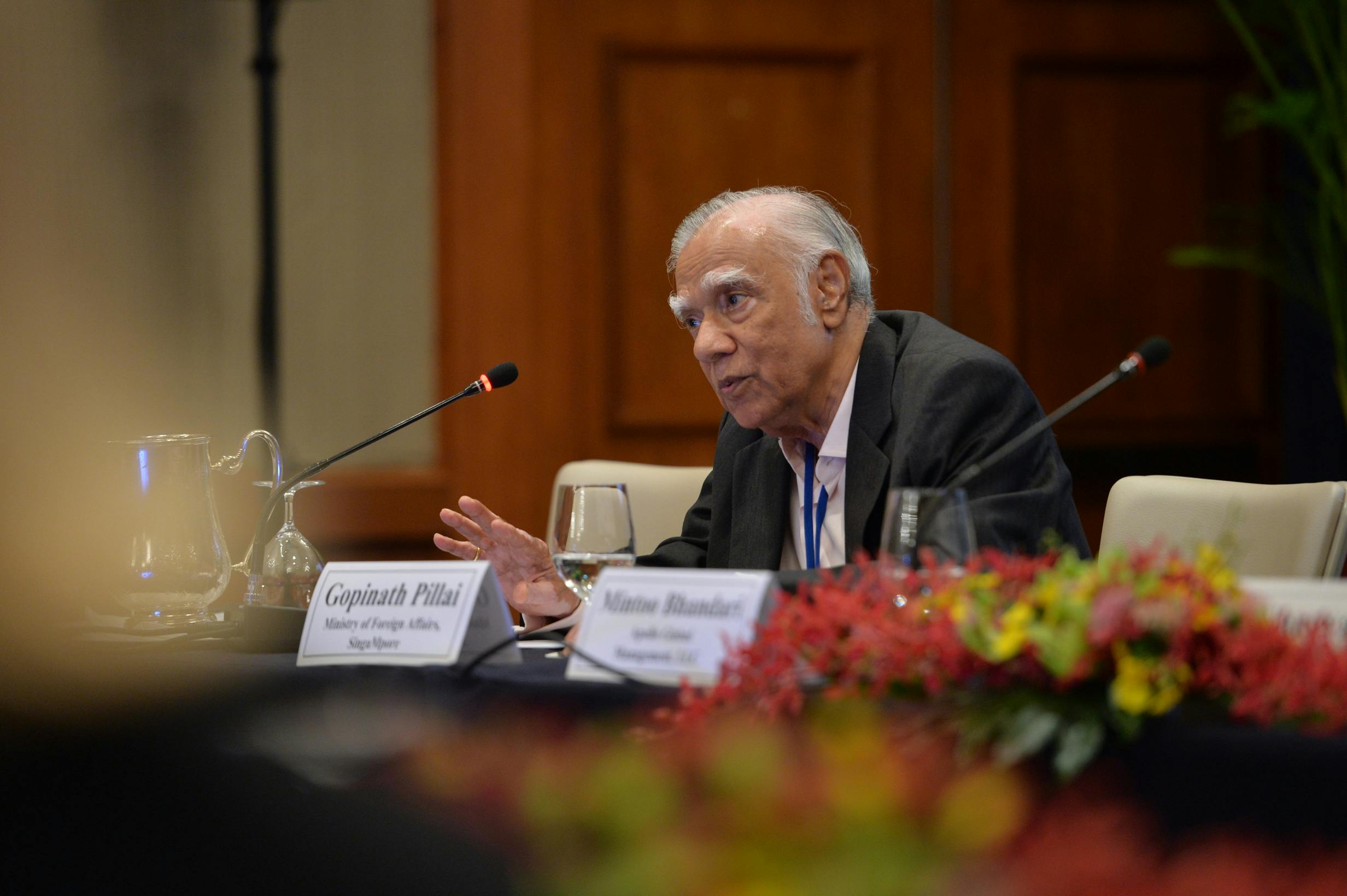 An older man speaking at a panel