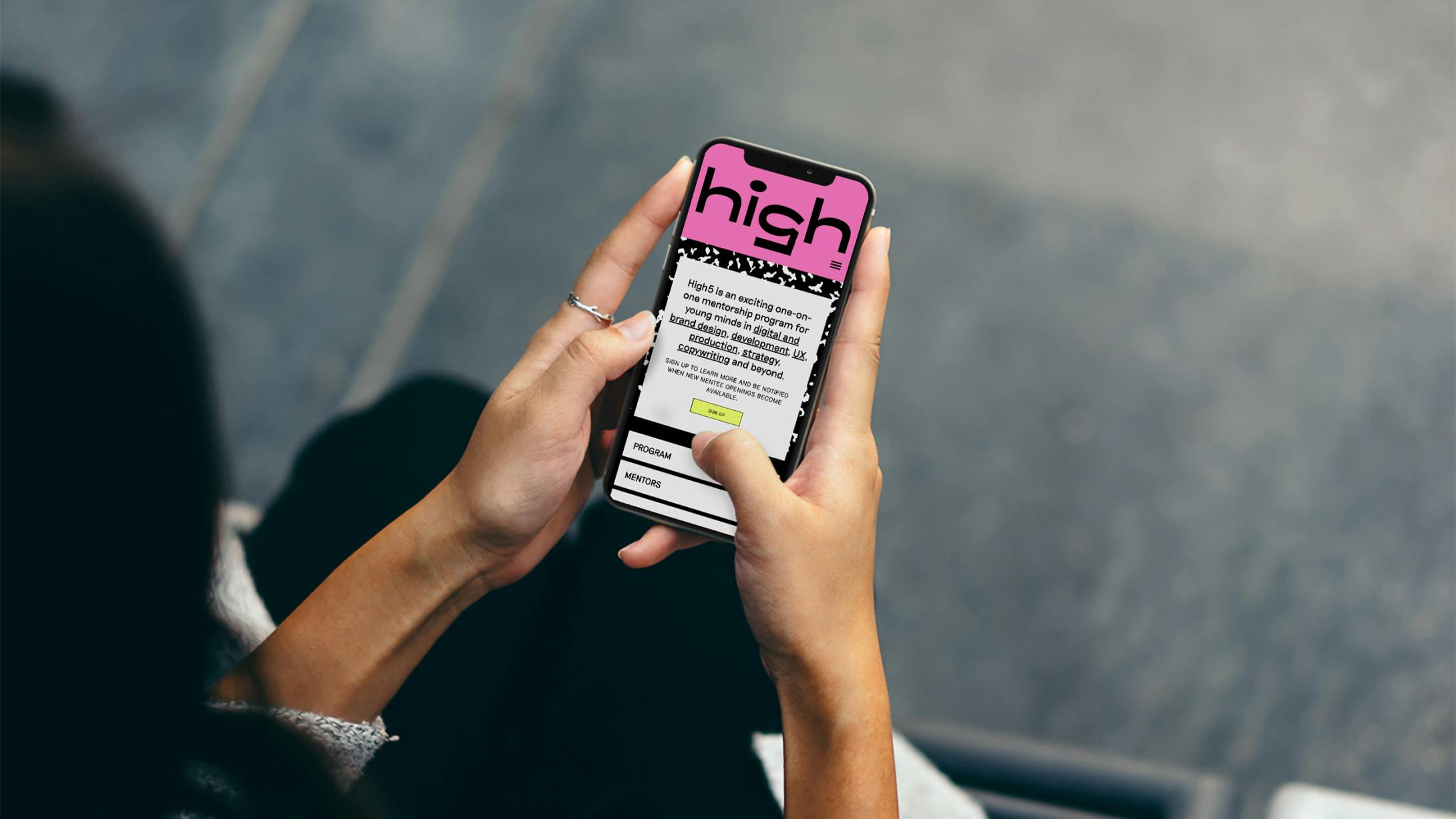 A woman looking at the High5 site on her phone