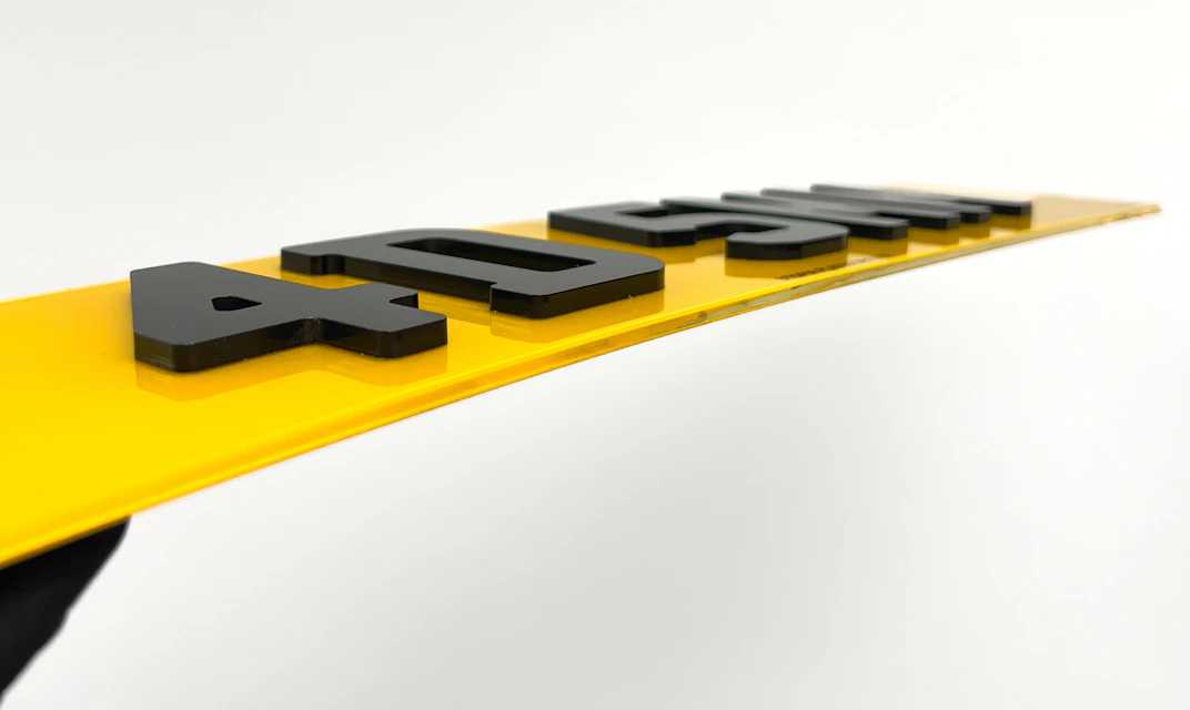 An angled shot of a 4D number plate with the 5mm letter style