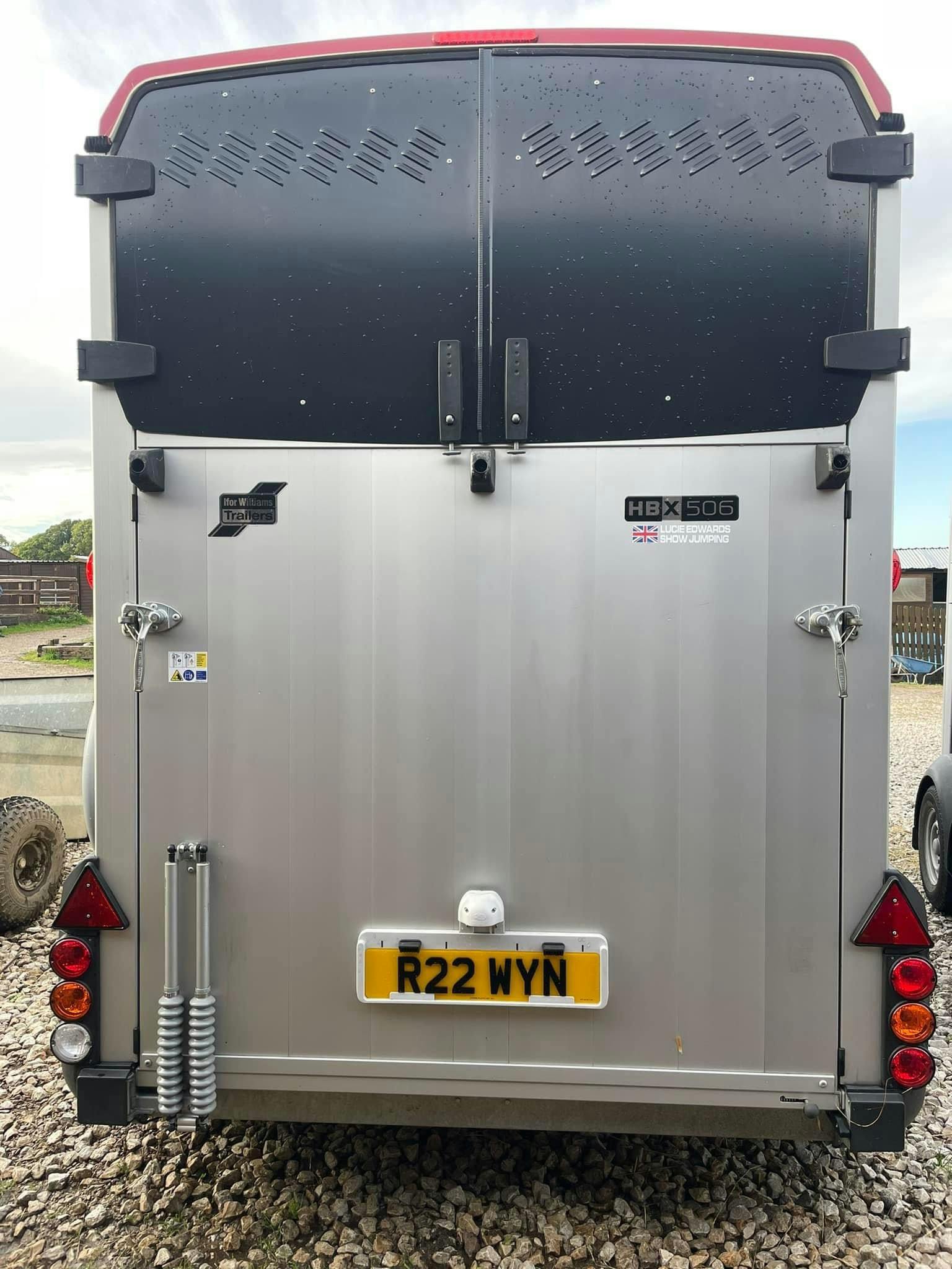 The rear doors of a horse box with a 4D 5mm number plate