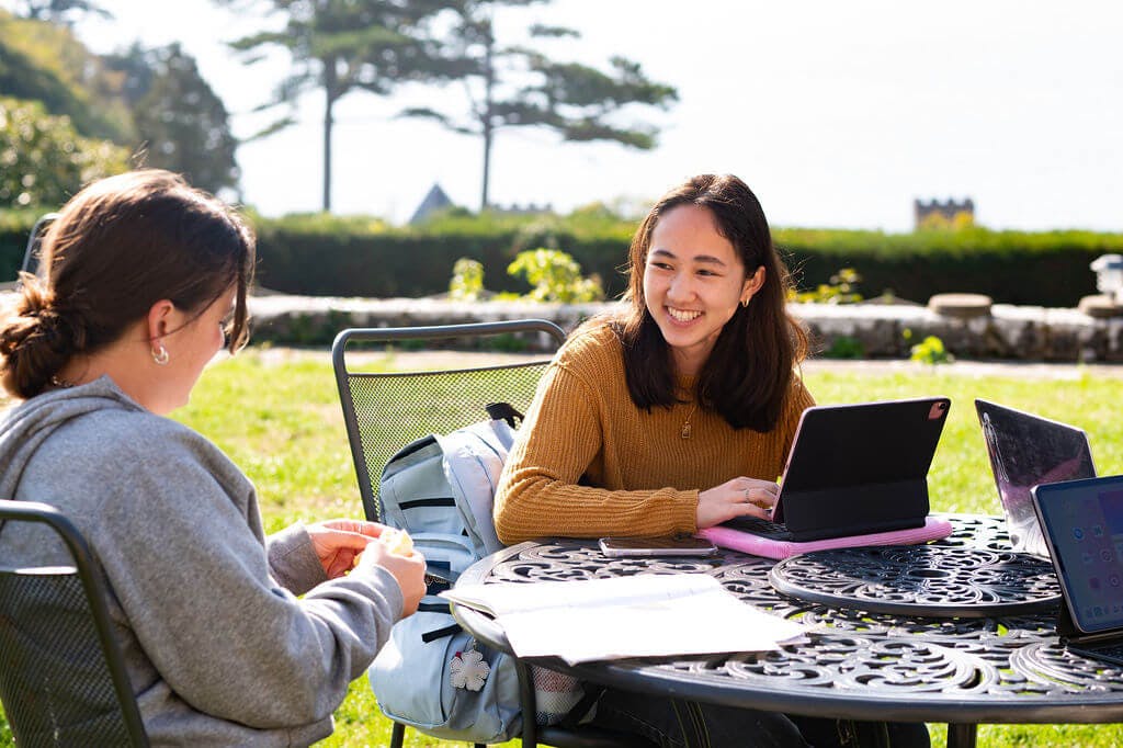 Students at table with laptop