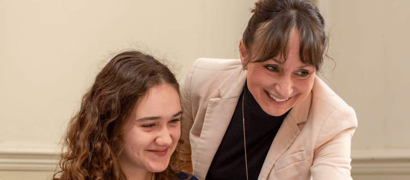 Teacher and pupil smiling