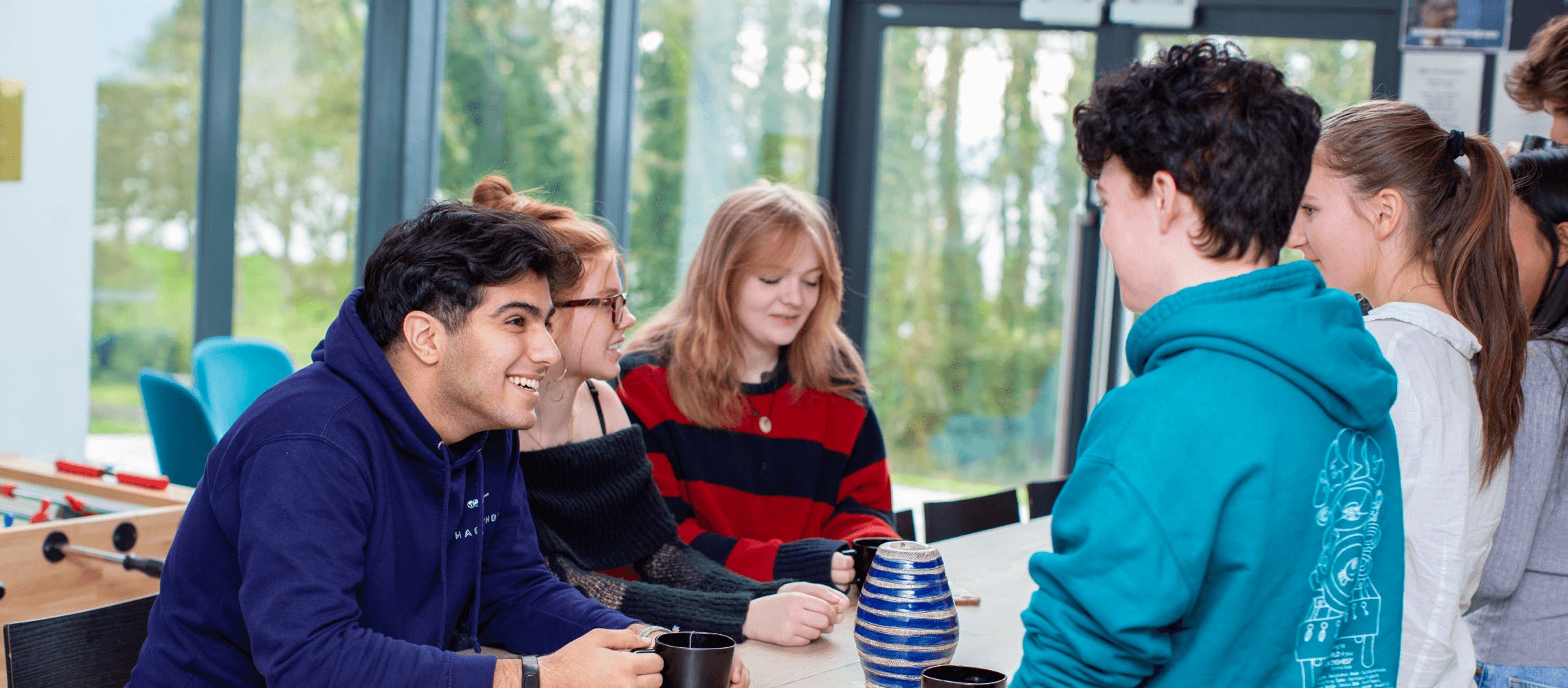 students chatting around a table