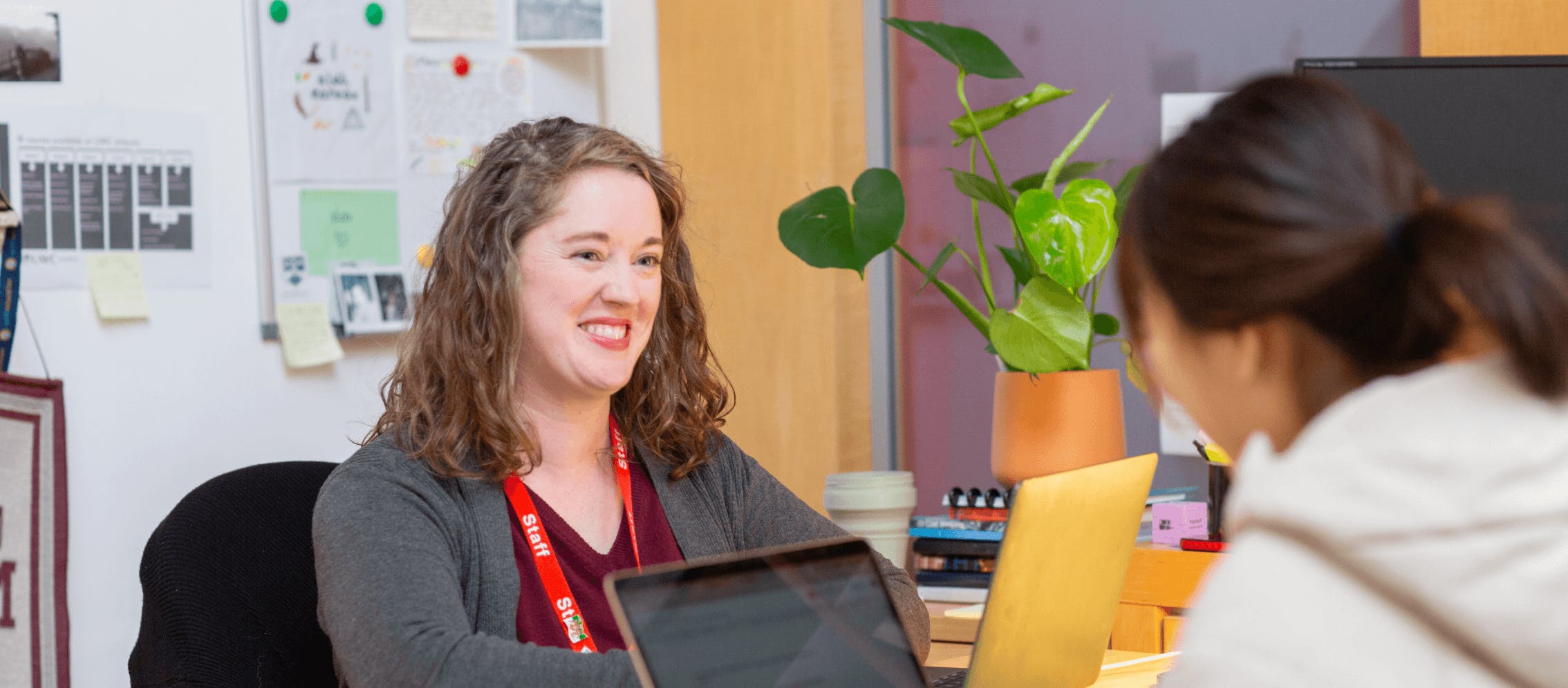 teacher with a student at their laptops