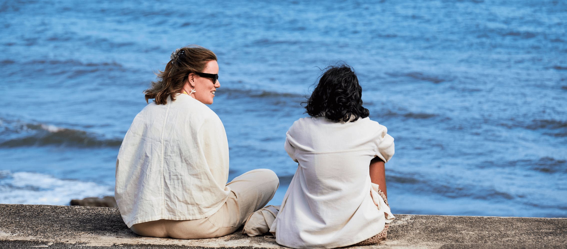 alumni chatting on the seafront