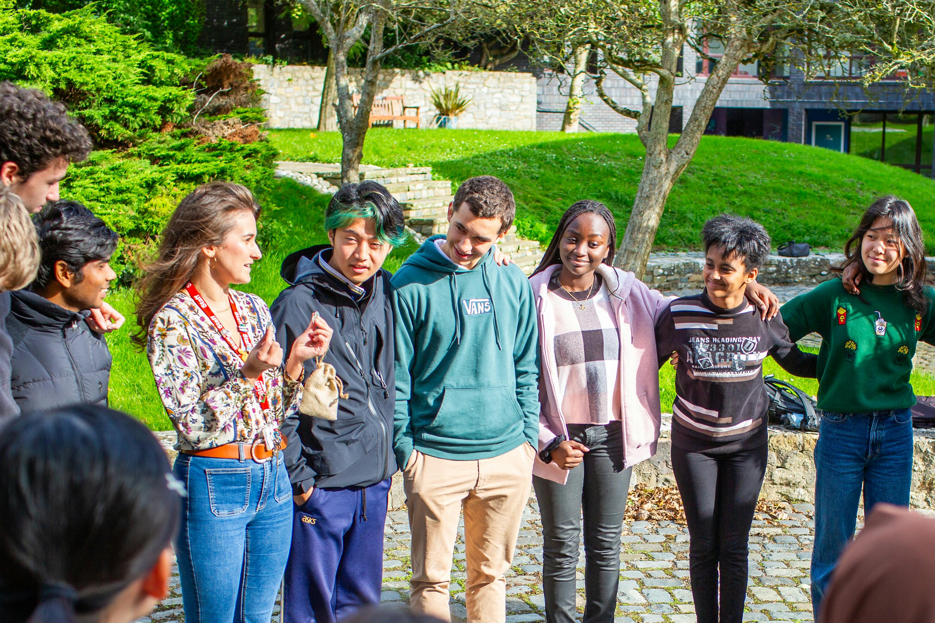 students with a teacher in a circle