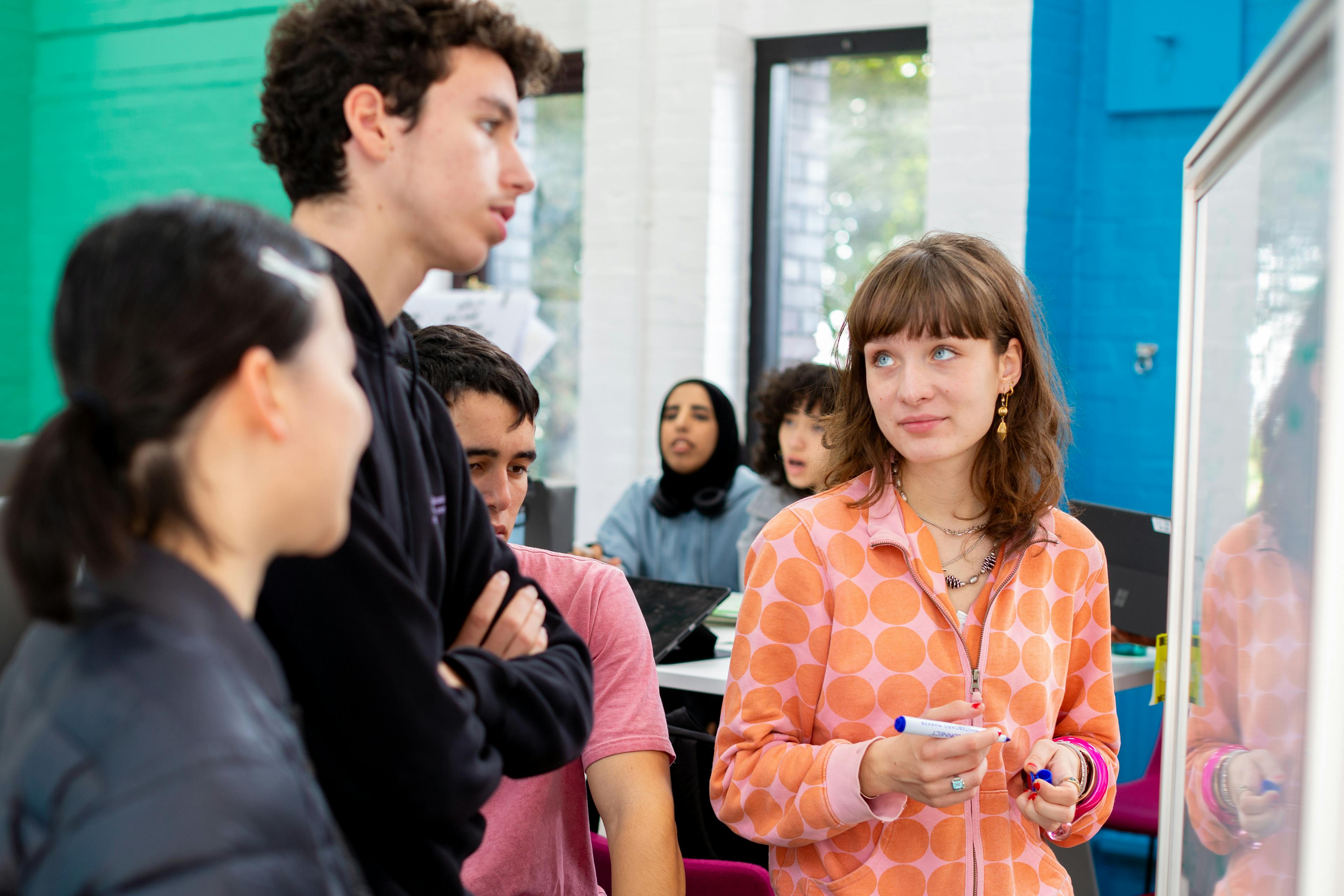 teacher with students at a whiteboard