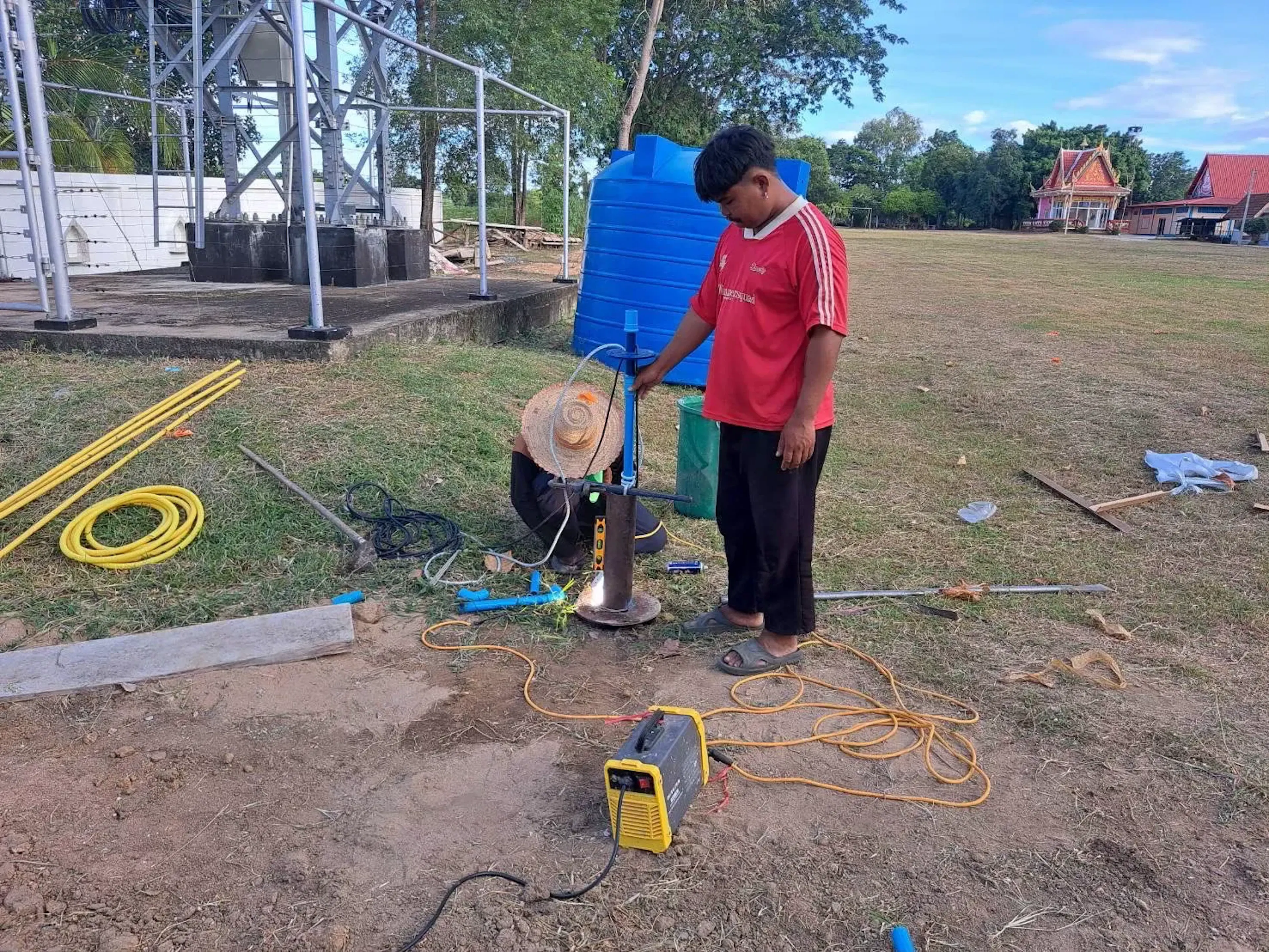 Roon and local Nepalese residents setting up a community-owned, solar-powered groundwater system