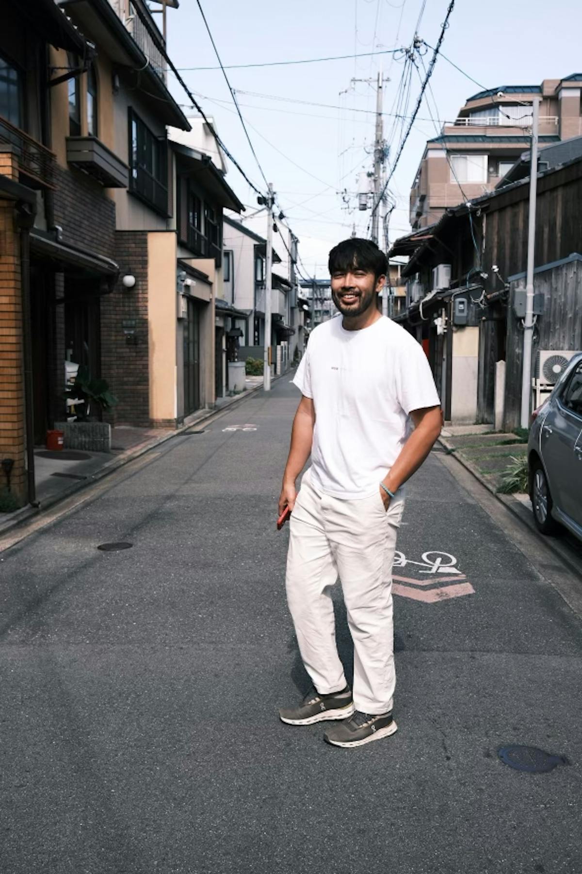 A man wearing all white in an urban landscape