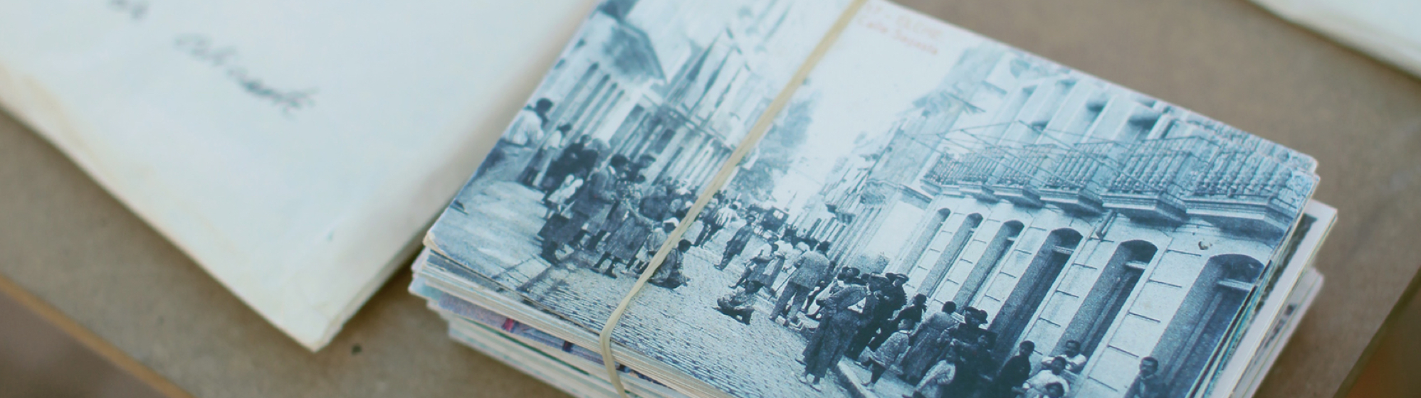 stack of vintage postcards tied with string