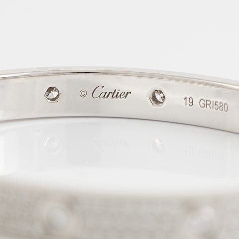 Cartier mark on a white gold and diamond bracelet.