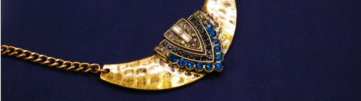gold tone necklace with blue rhinestones