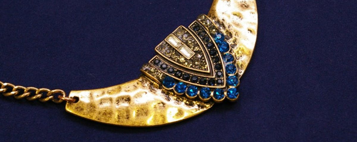 gold tone necklace with blue rhinestones