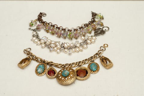 Collection of three costume jewelry charm bracelets