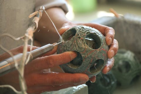 man carving jade stone