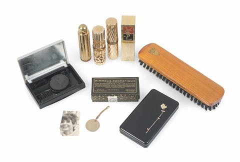 A collection of Greta Garbo’s vintage makeup items which includes a Lancome compact with a cake mascara