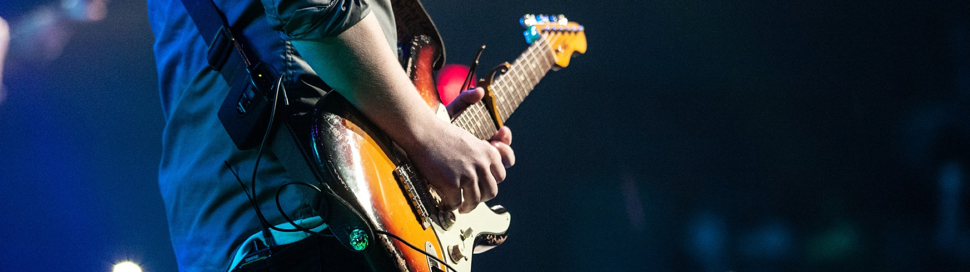 man playing an electric guitar
